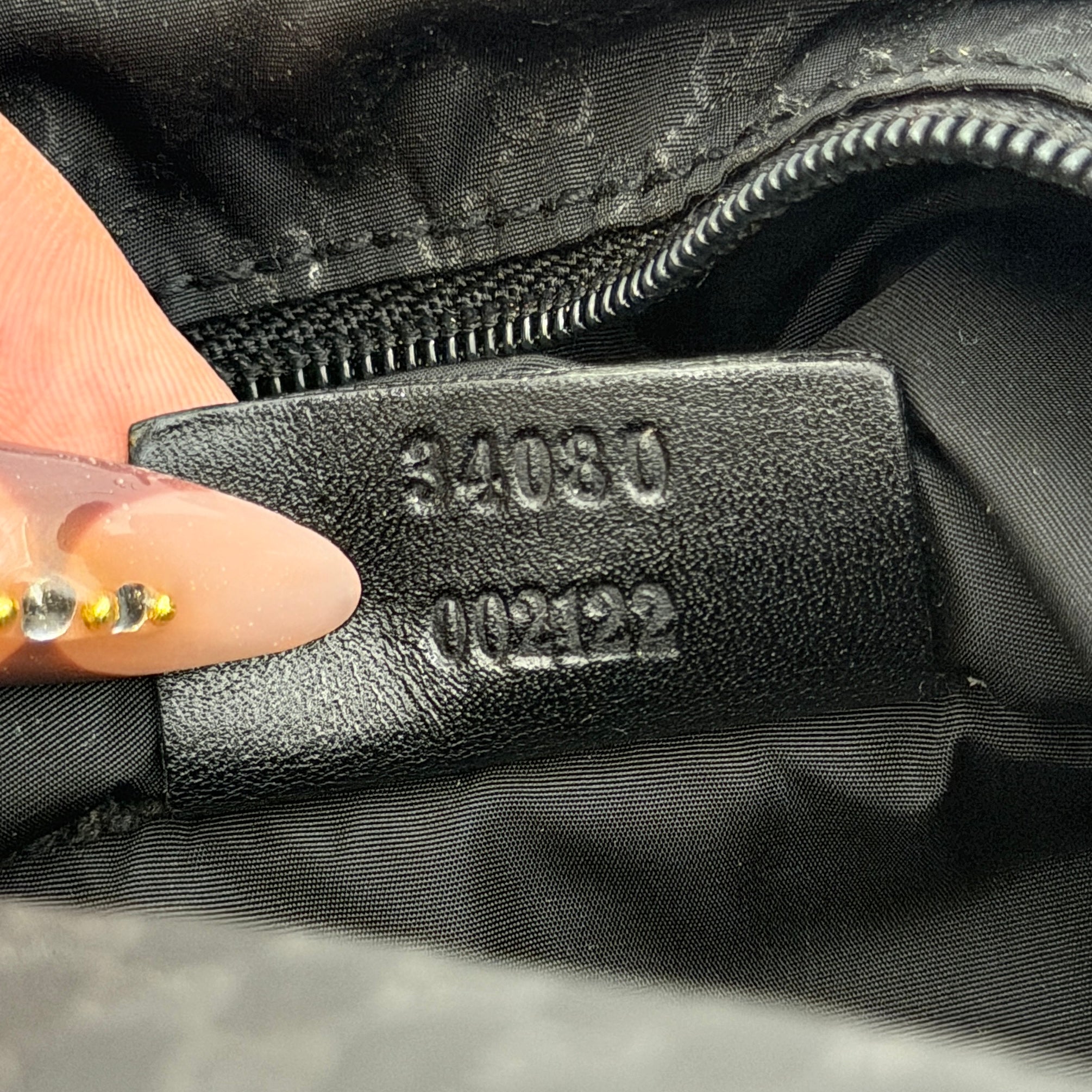 Gucci GG Monogram Mini Hobo black nylon shoulder bag with leather trim and silver-tone hardware, displayed on a plain background.