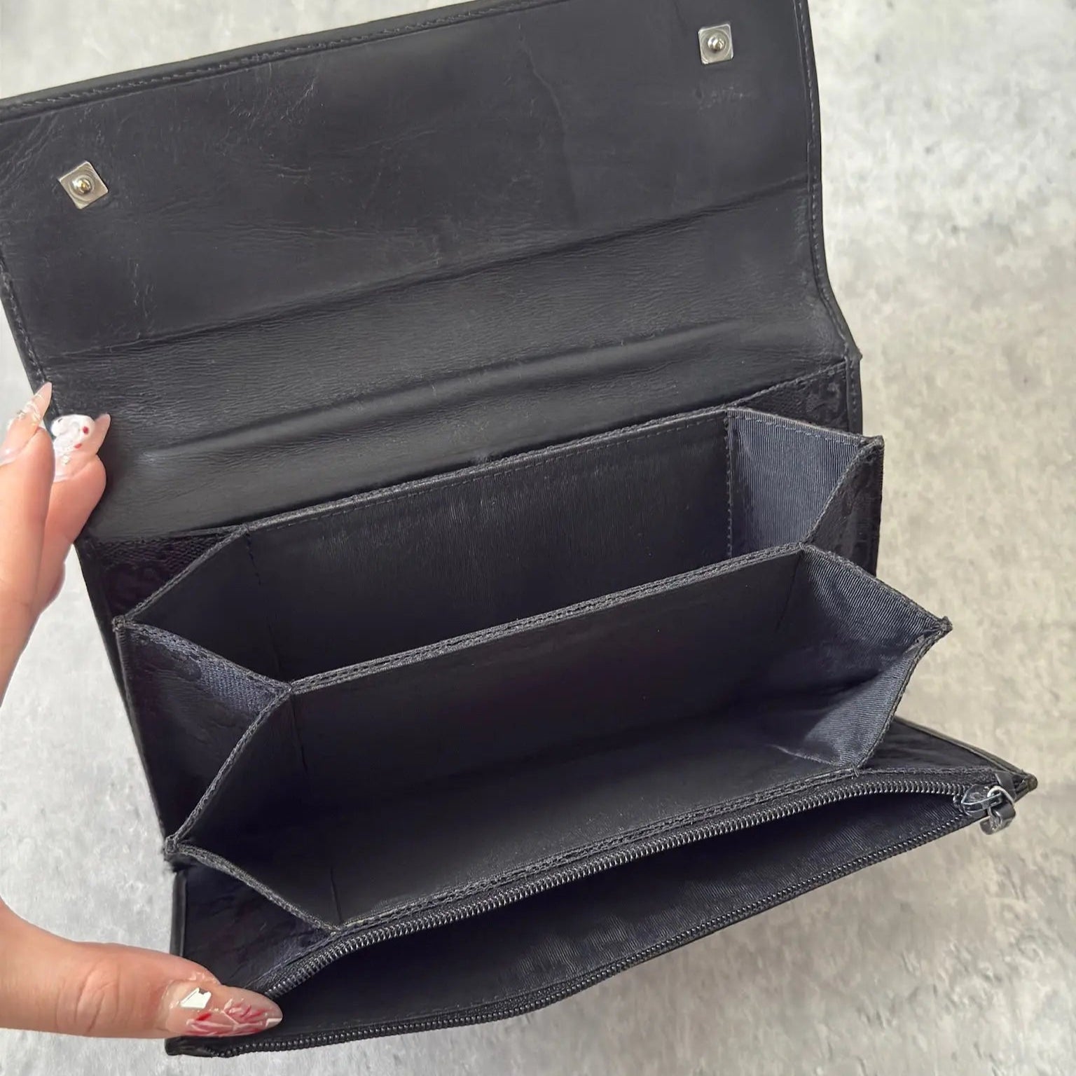 Gucci Monogram Black Bifold Long Wallet with snap-button closure and multiple compartments.