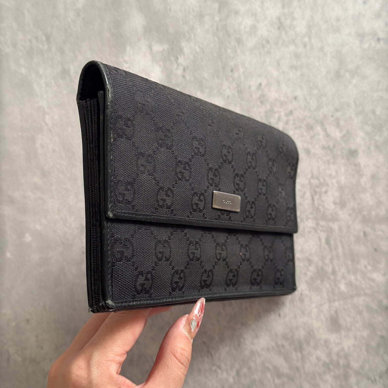 Gucci Monogram Black Bifold Long Wallet with snap-button closure and multiple compartments.