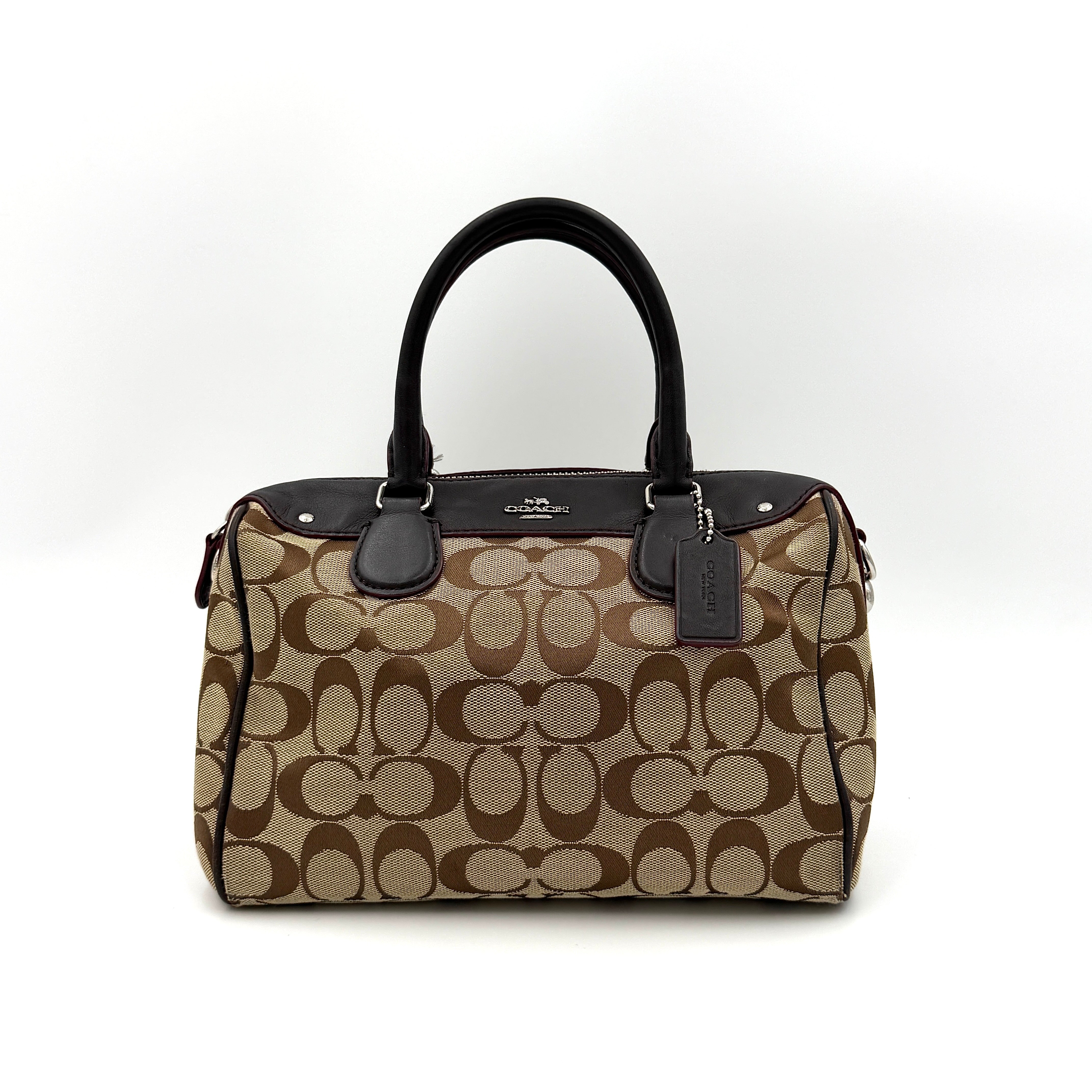 Coach Mini Bennett Boston Bag in beige monogram canvas with brown leather trim, dual handles, and detachable crossbody strap.