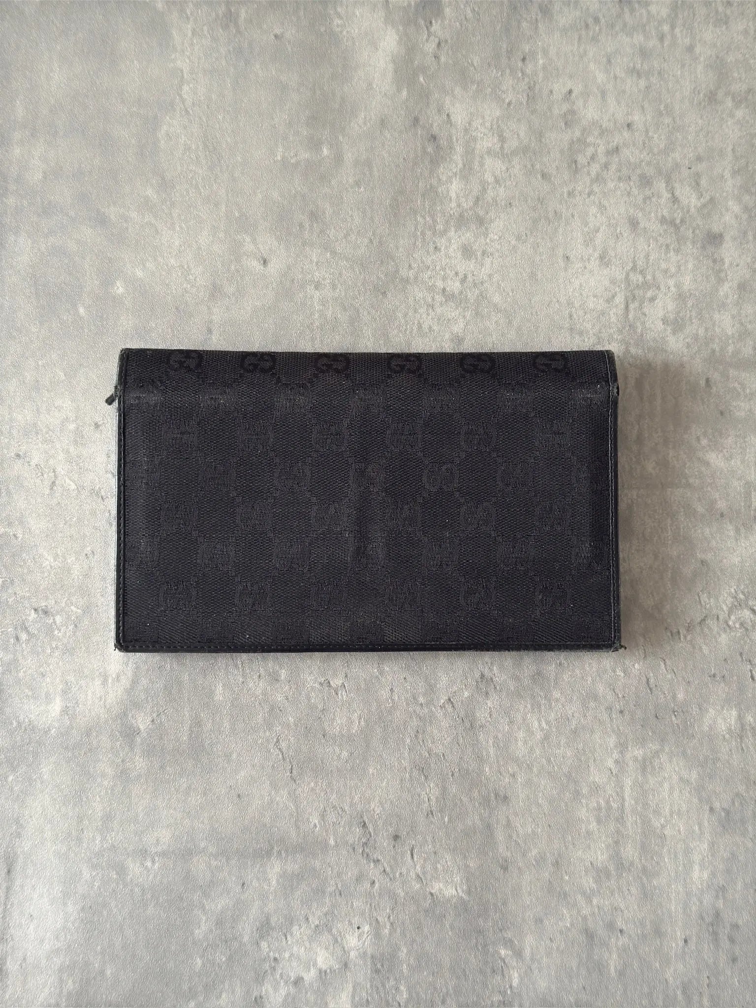 Gucci Monogram Black Bifold Long Wallet with snap-button closure and multiple compartments.