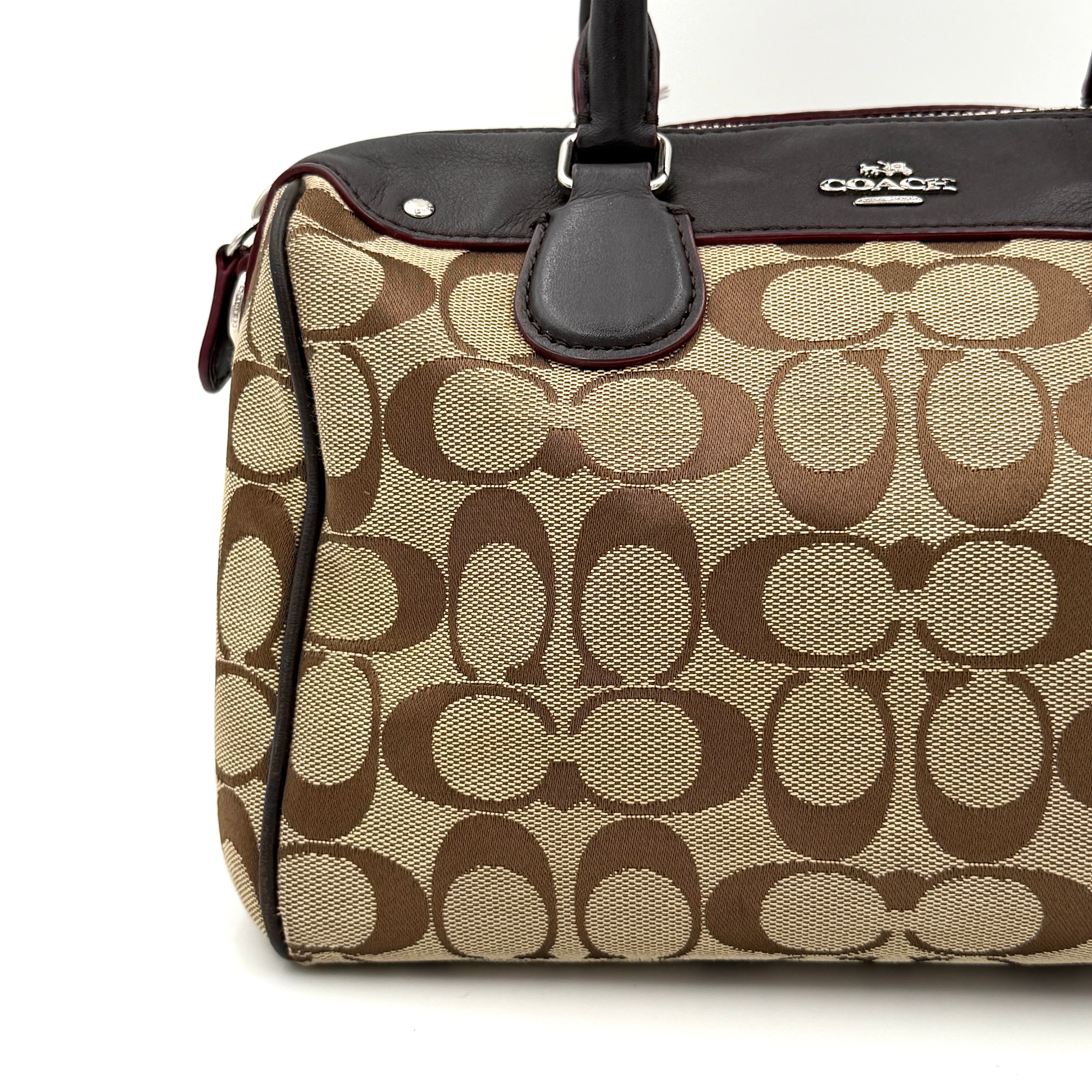 Coach Mini Bennett Boston Bag in beige monogram canvas with brown leather trim, dual handles, and detachable crossbody strap.