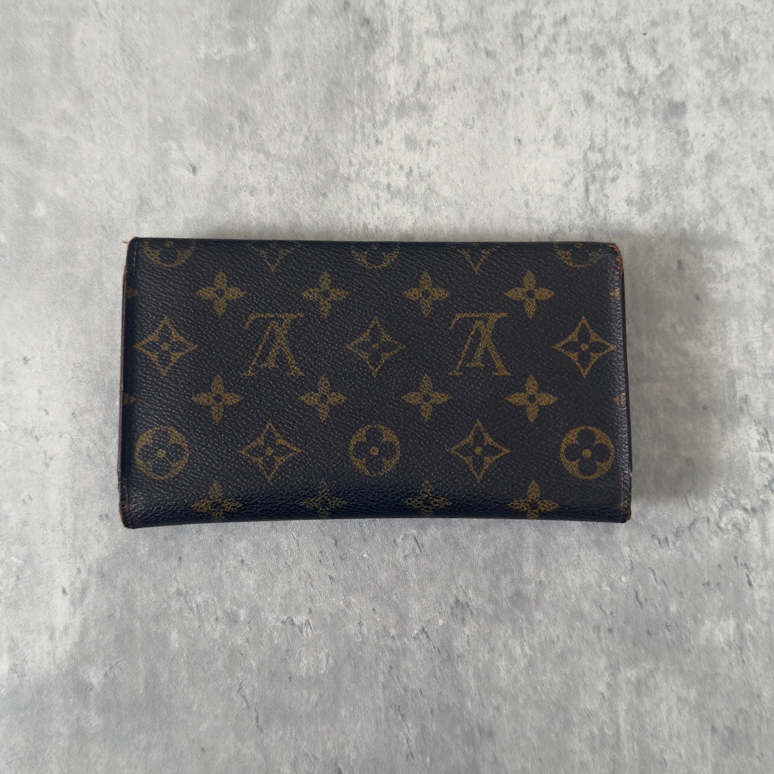 Luxurious Louis Vuitton Monogram Portefeuille Sarah Long Wallet, showcasing the iconic LV print and a spacious, organized interior, perfect for everyday sophistication.