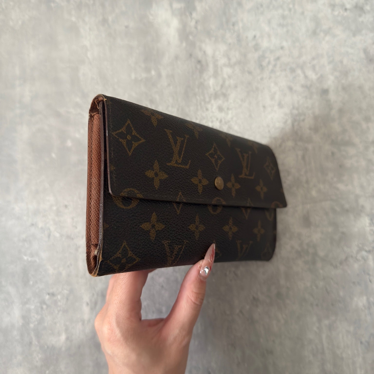 Luxurious Louis Vuitton Monogram Portefeuille Sarah Long Wallet, showcasing the iconic LV print and a spacious, organized interior, perfect for everyday sophistication.