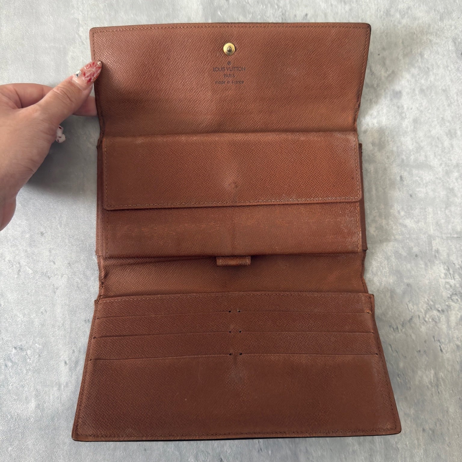 Luxurious Louis Vuitton Monogram Portefeuille Sarah Long Wallet, showcasing the iconic LV print and a spacious, organized interior, perfect for everyday sophistication.