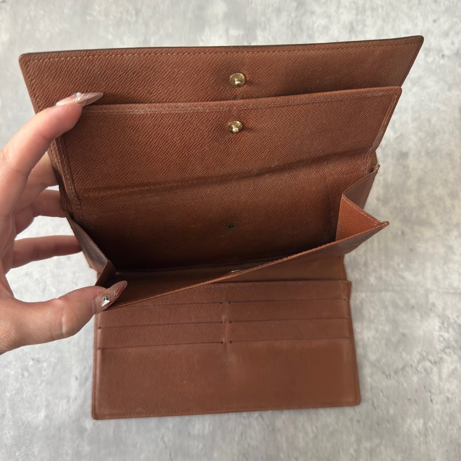 Luxurious Louis Vuitton Monogram Portefeuille Sarah Long Wallet, showcasing the iconic LV print and a spacious, organized interior, perfect for everyday sophistication.