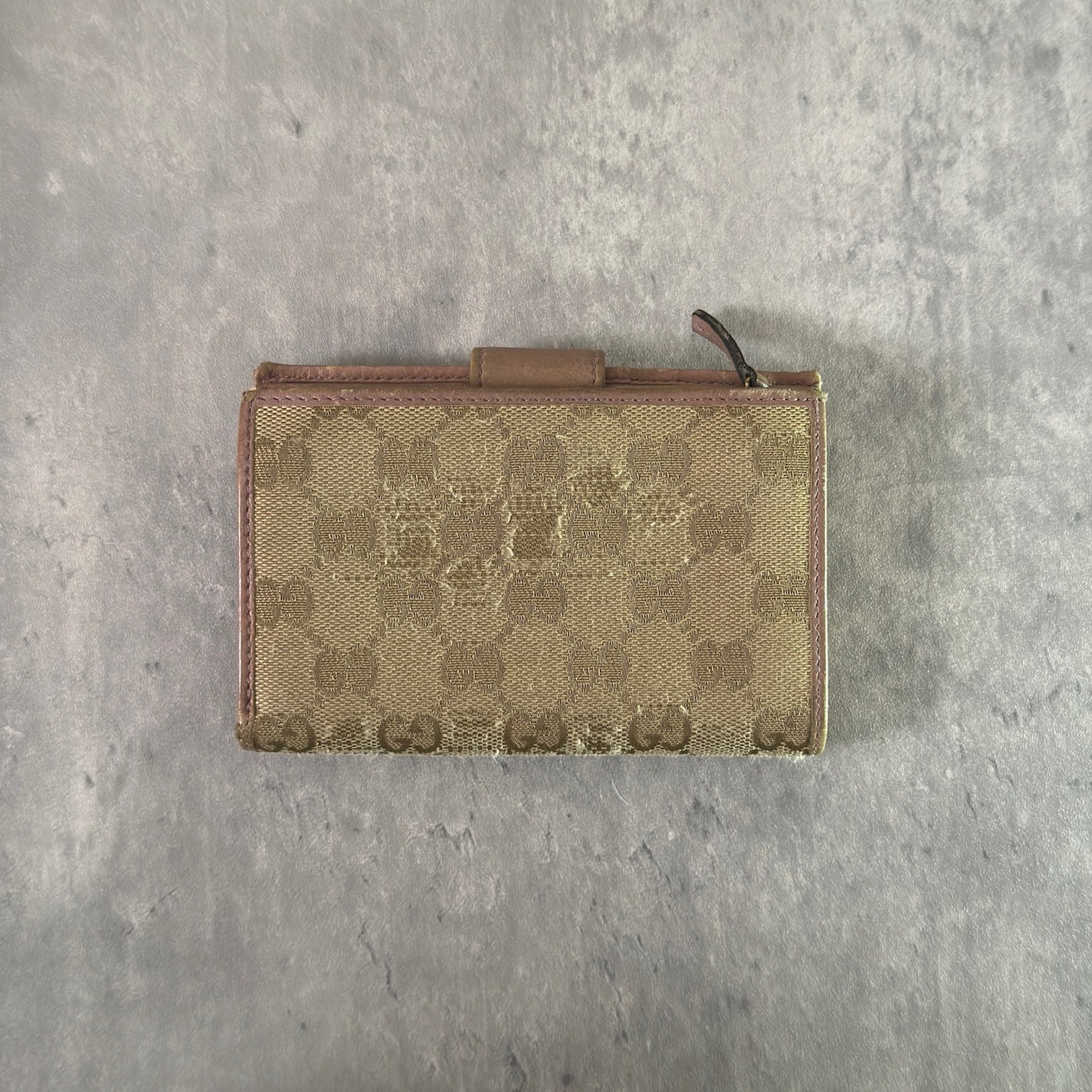 Gucci GG Logo Canvas Bifold Wallet in Pink/Beige with snap closure and multiple compartments, displaying minimal signs of wear.