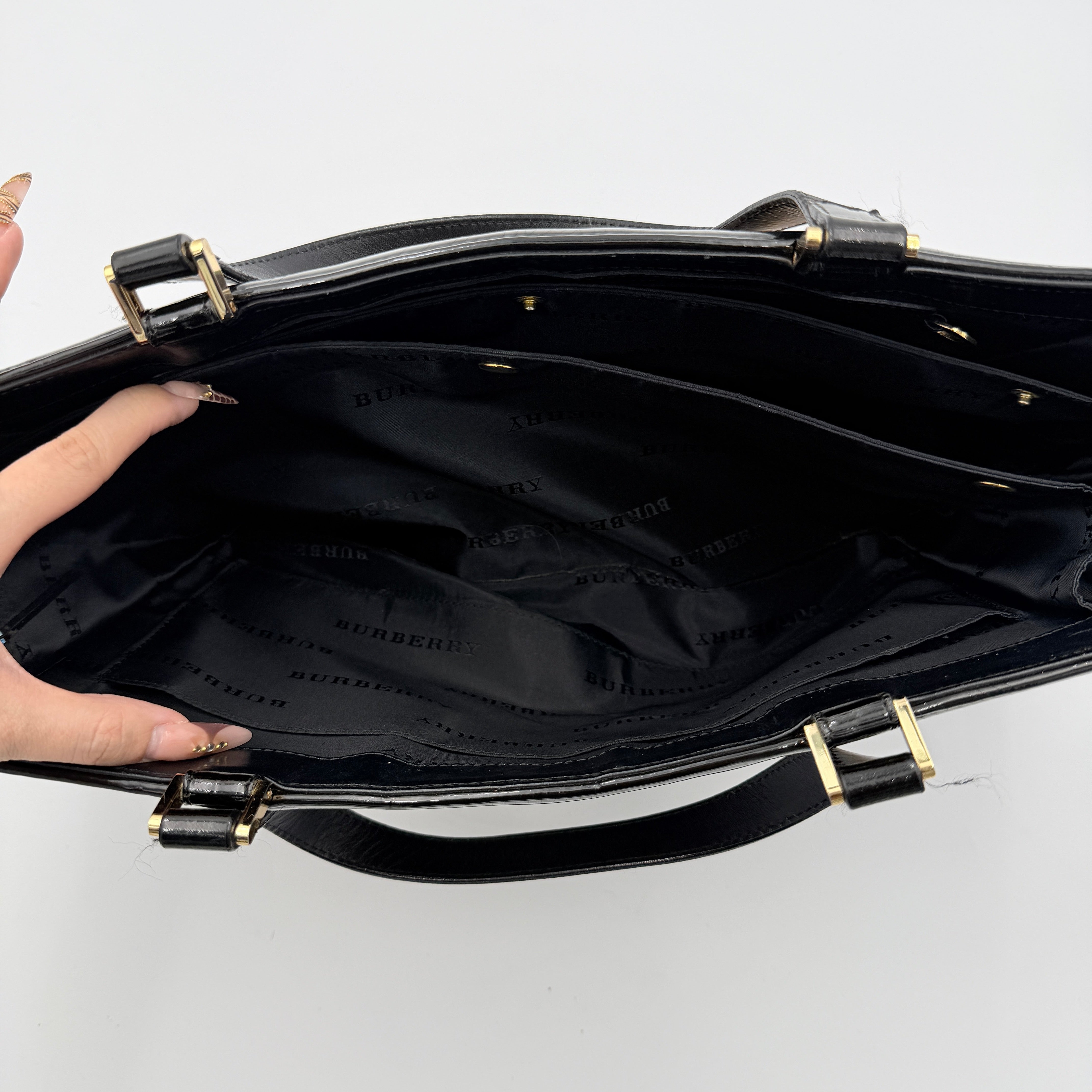 Burberry Nova Check Wool Shoulder Bag in beige and black wool with patent leather trim and double handles.