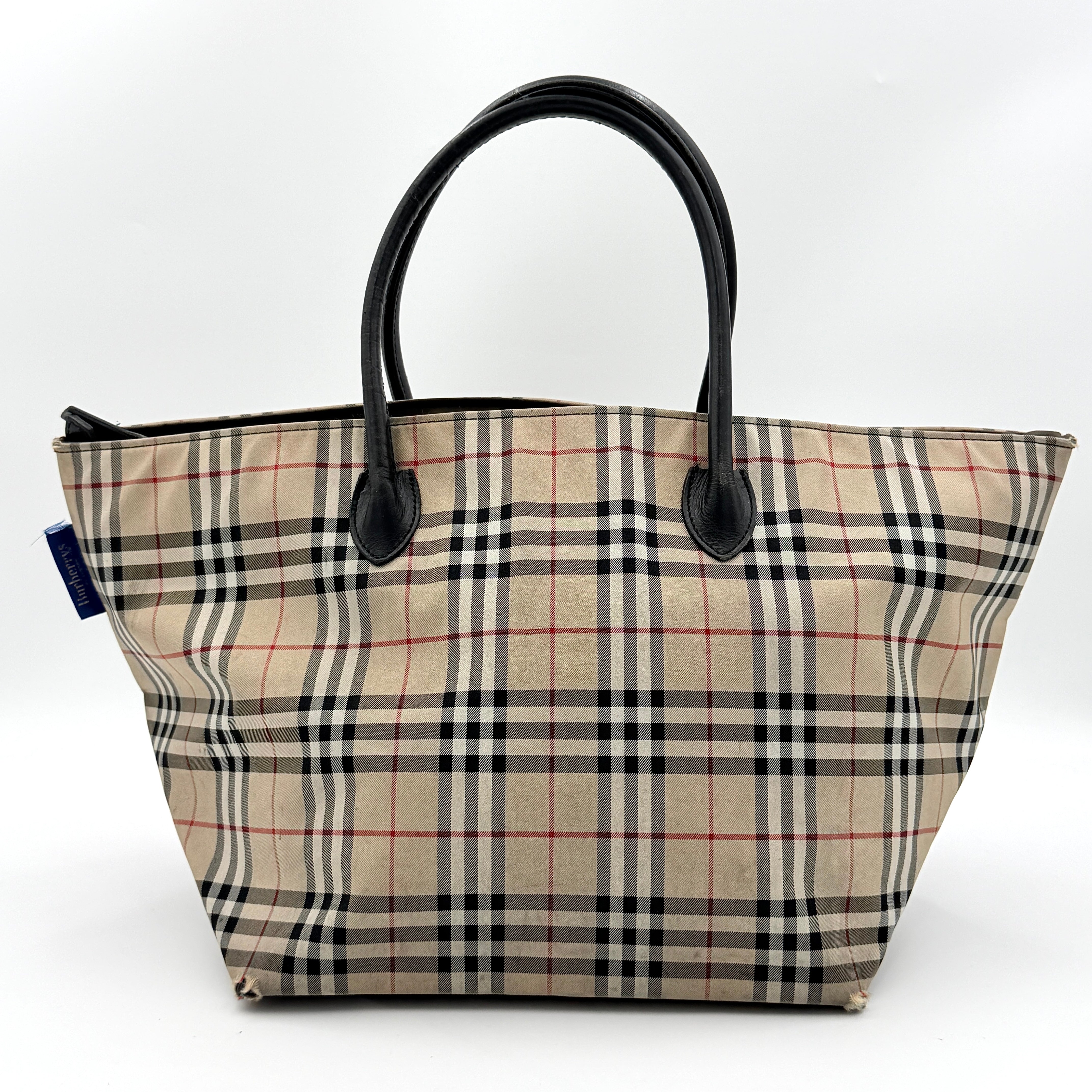 Burberry Nova Check shoulder bag in beige and black with black leather handles and zip closure.