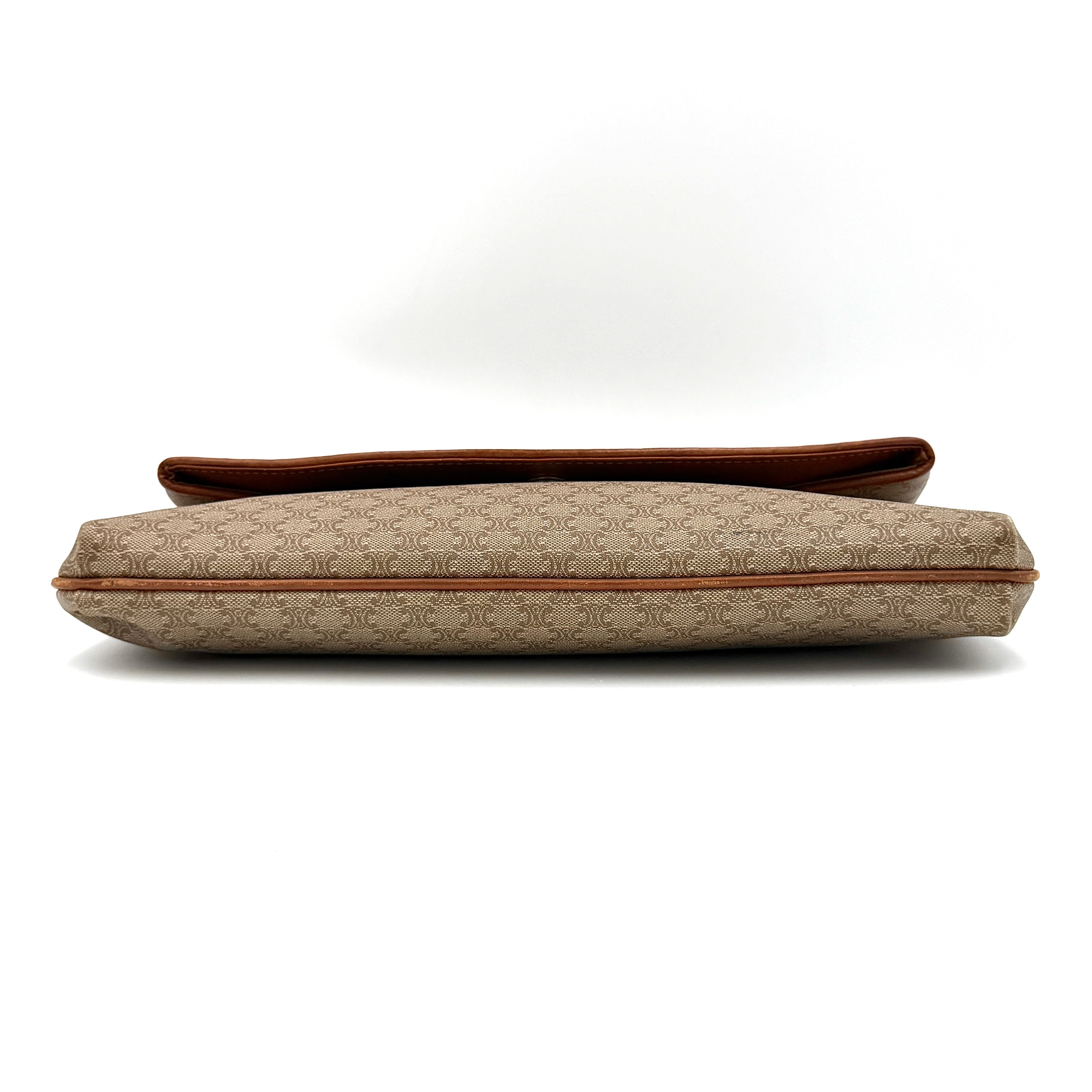 The Celine Macadam Clutch Bag in beige, featuring the iconic monogram canvas and tan leather trim, shown neatly closed with its signature emblem on the flap.