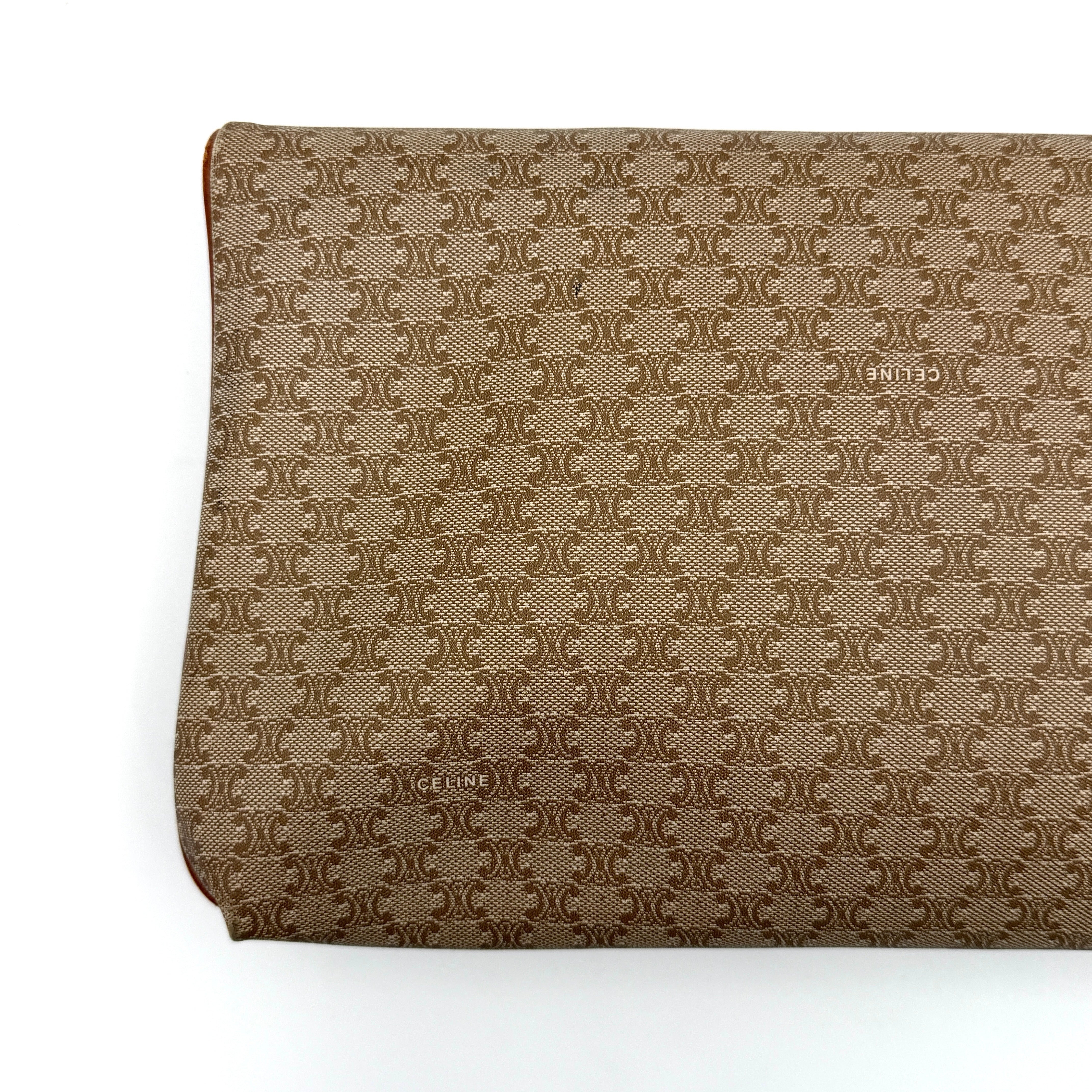 The Celine Macadam Clutch Bag in beige, featuring the iconic monogram canvas and tan leather trim, shown neatly closed with its signature emblem on the flap.