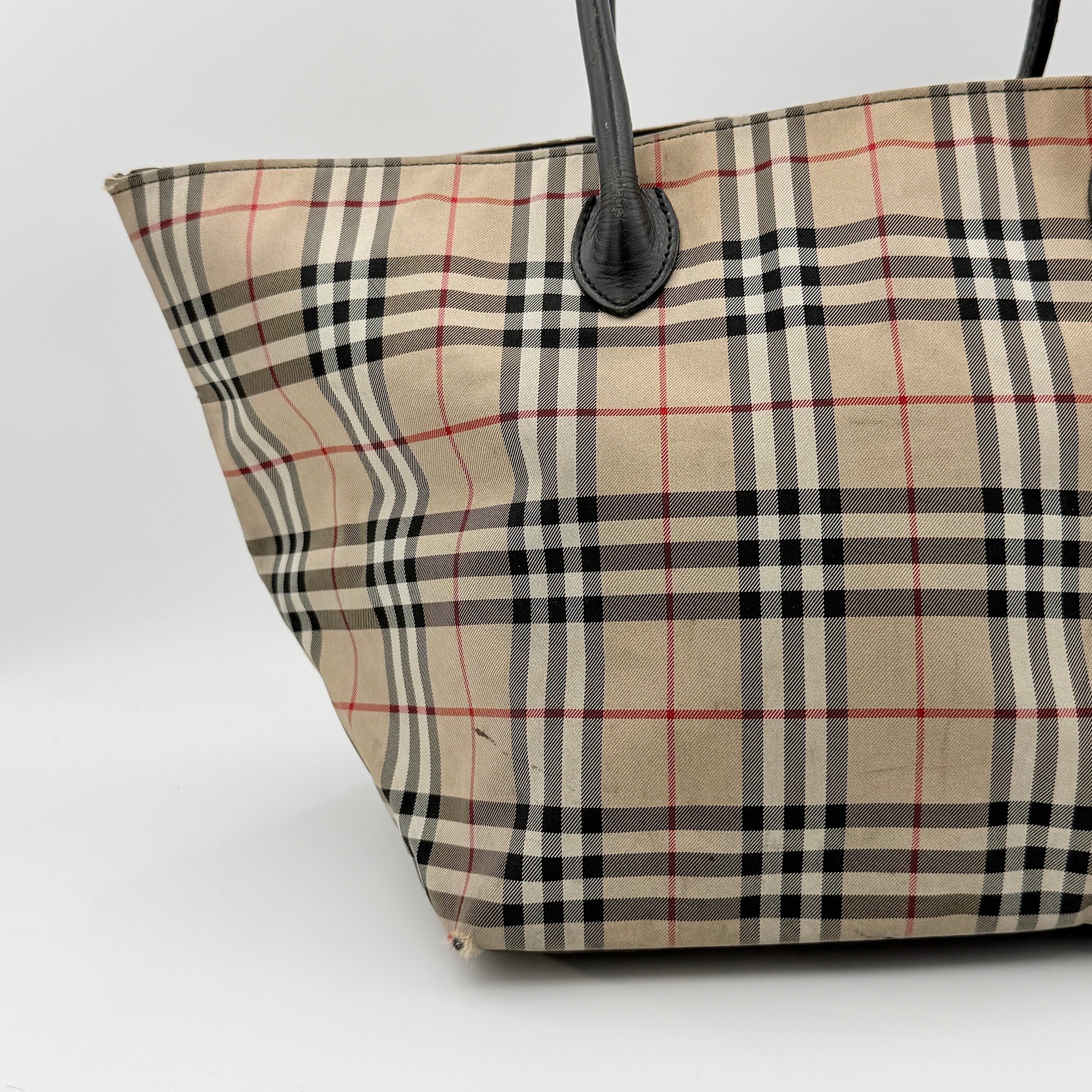 Burberry Nova Check shoulder bag in beige and black with black leather handles and zip closure.