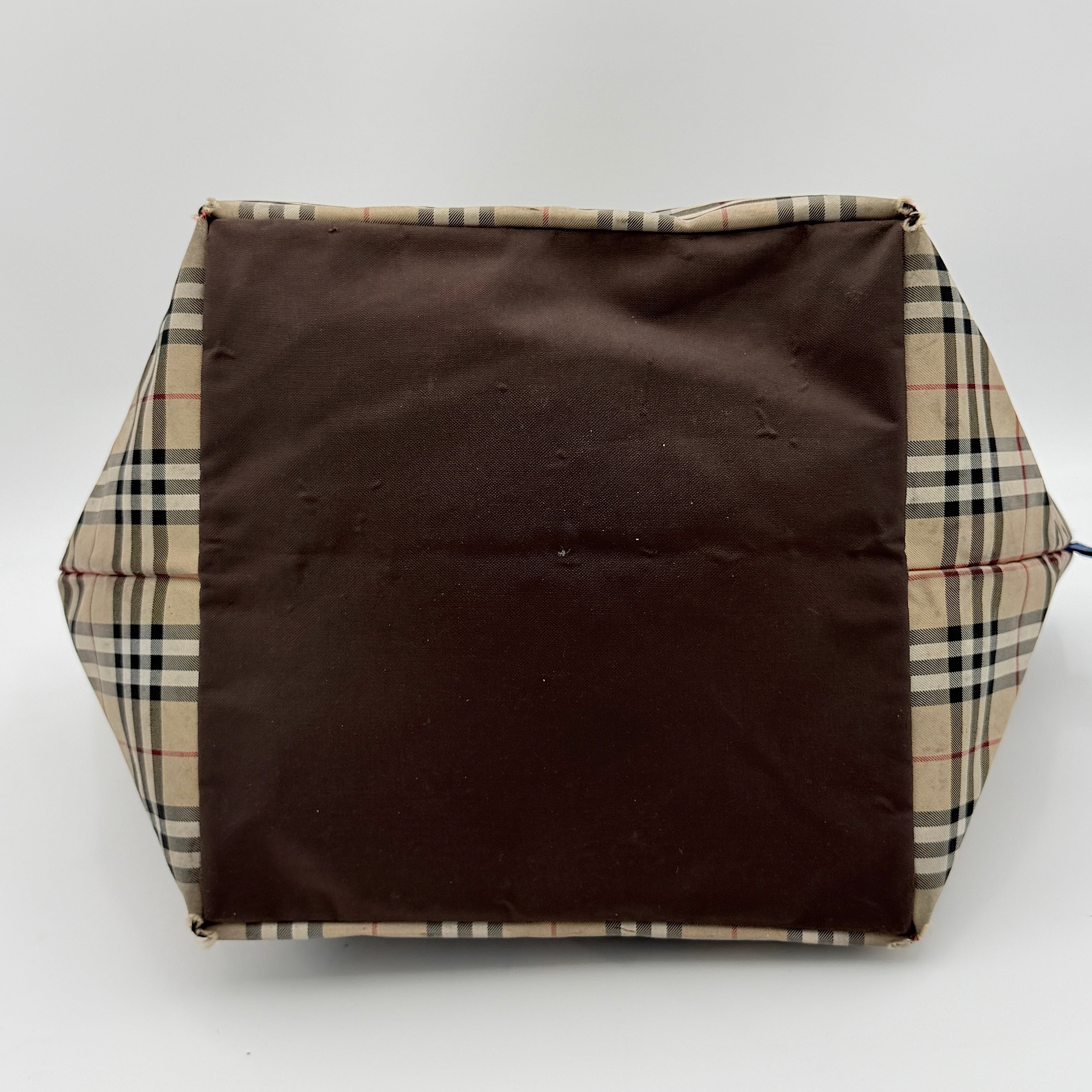 Burberry Nova Check shoulder bag in beige and black with black leather handles and zip closure.