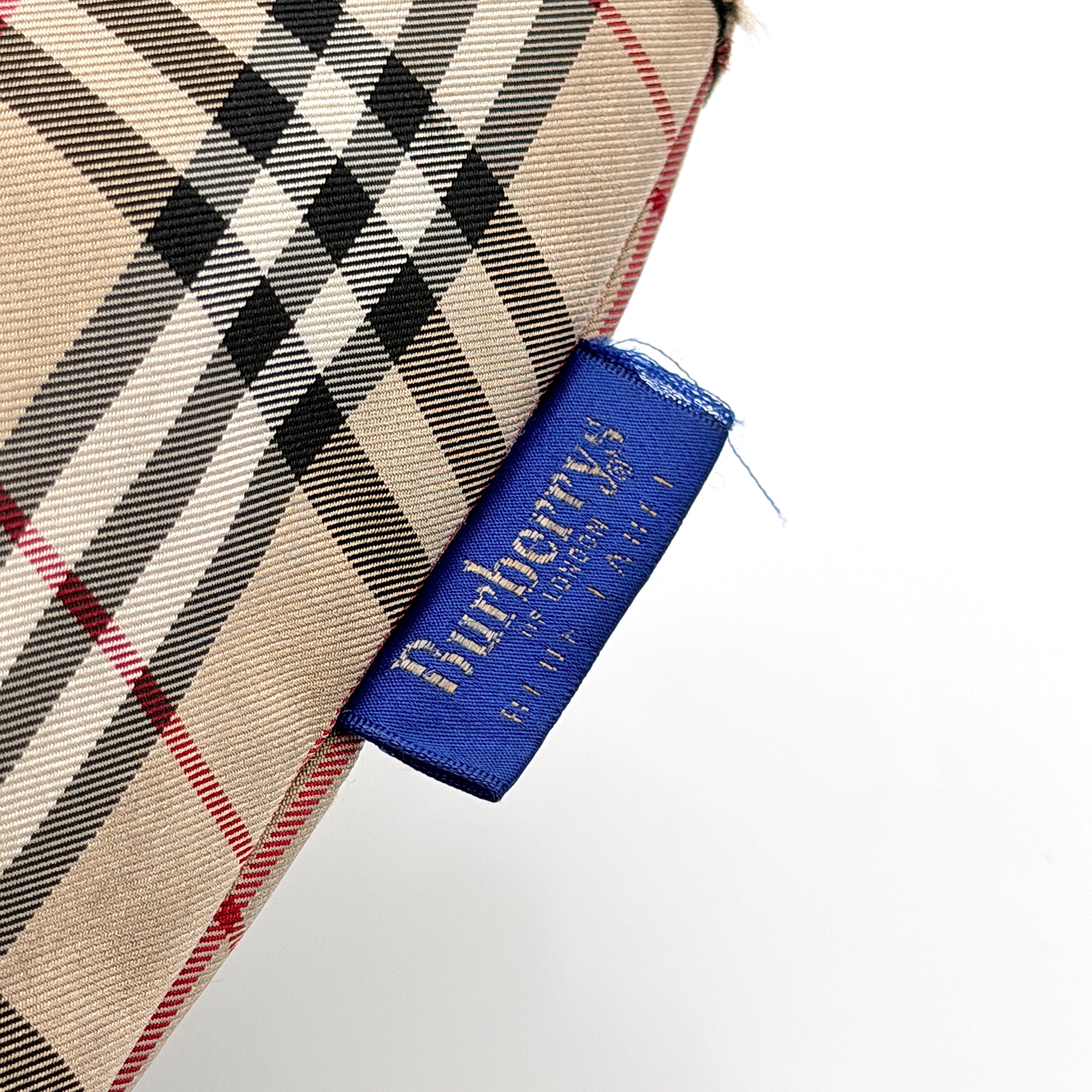 Burberry Nova Check shoulder bag in beige and black with black leather handles and zip closure.