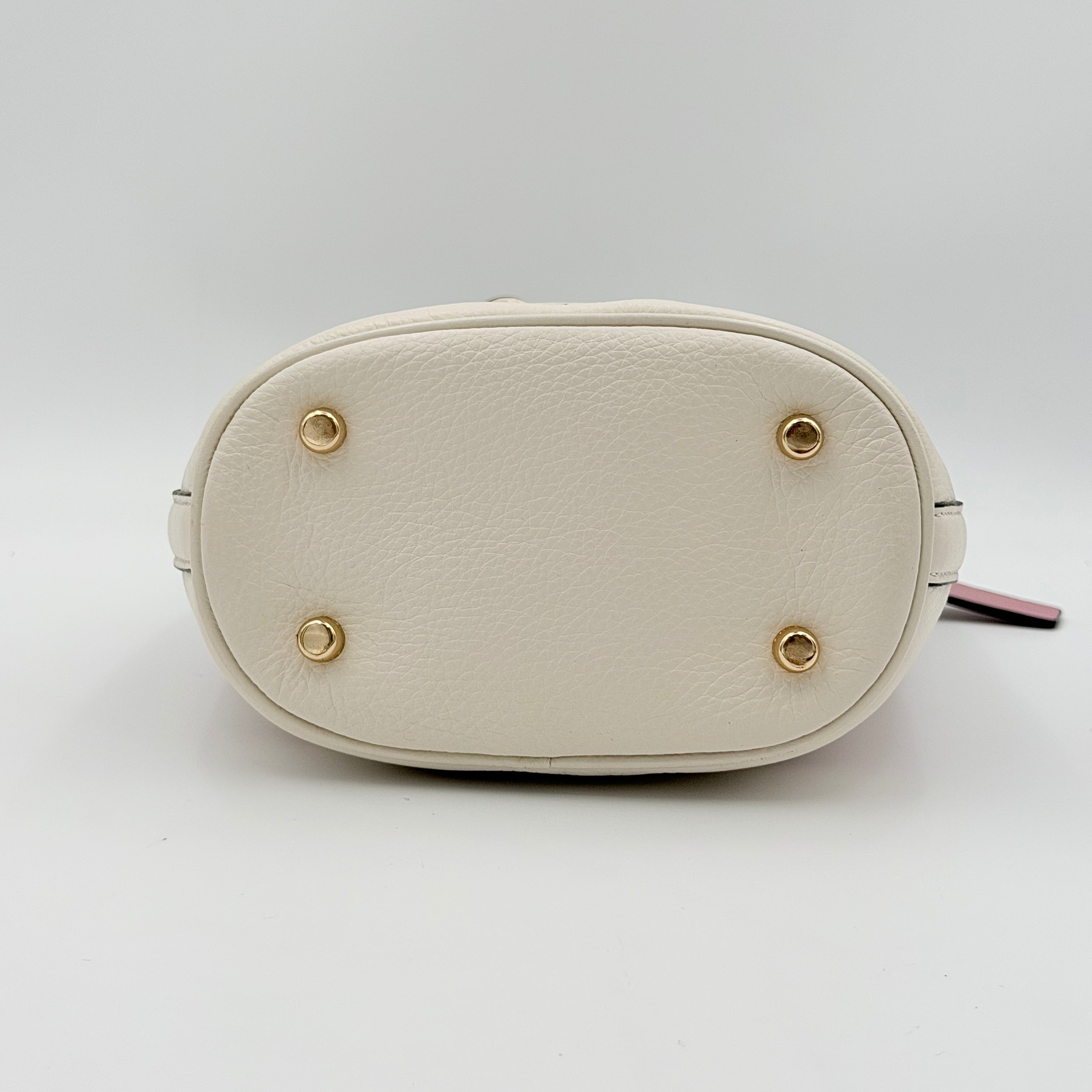 Coach Signature Dempsey 19 bucket bag in pink and white canvas with white leather trim and detachable strap.