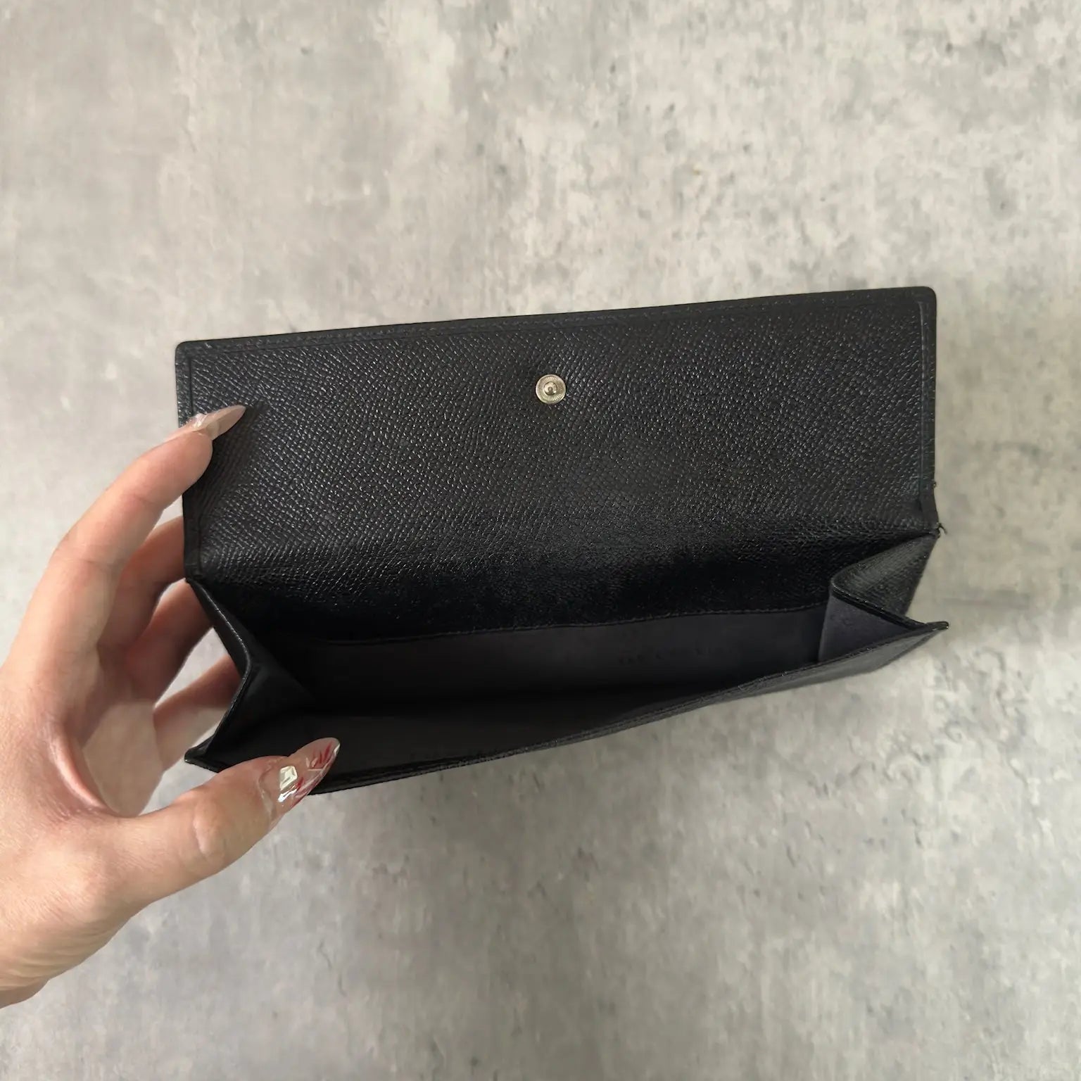 Bvlgari Classico Long Wallet in black leather, featuring a silver-tone logo clasp, multiple card slots, and a spacious bill compartment, showcasing understated luxury and sophistication.