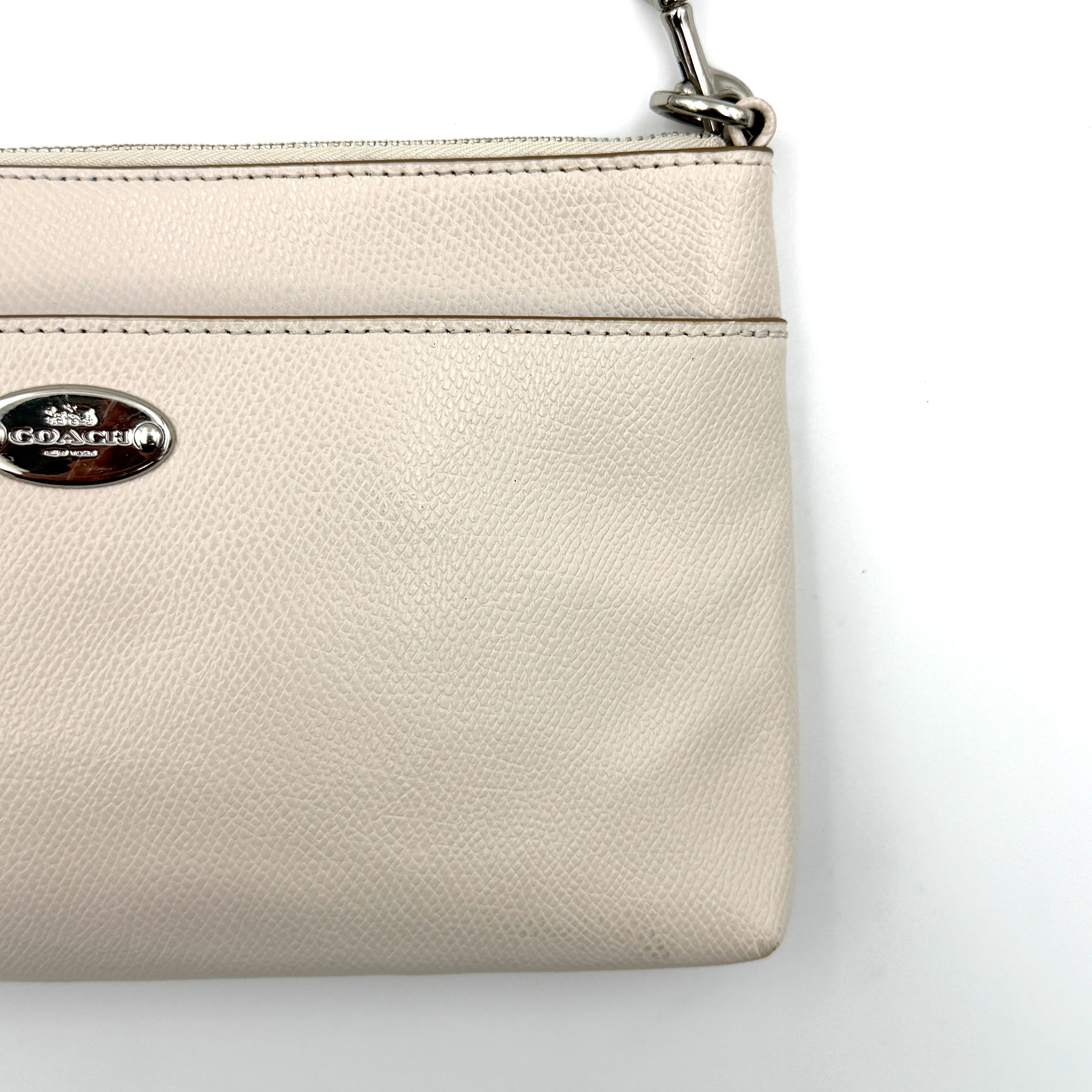 Coach 2in1 Floral Pop Pouch Shoulder Bag in ivory leather with detachable top handle and silver hardware, featuring a navy floral printed insert.