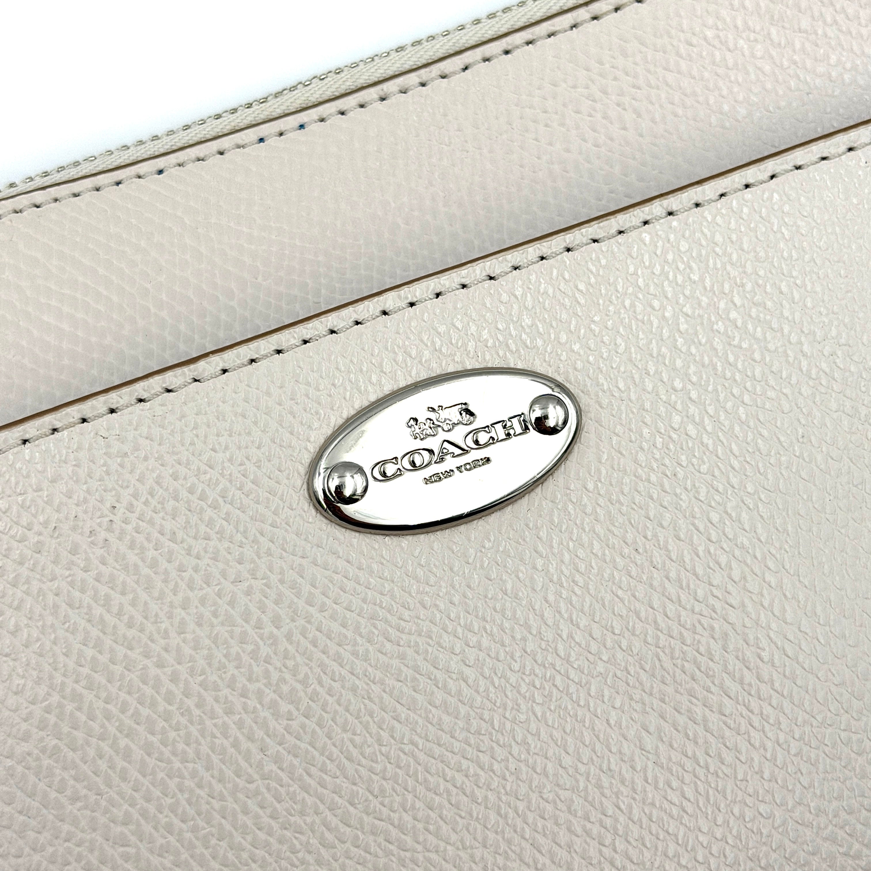 Coach 2in1 Floral Pop Pouch Shoulder Bag in ivory leather with detachable top handle and silver hardware, featuring a navy floral printed insert.
