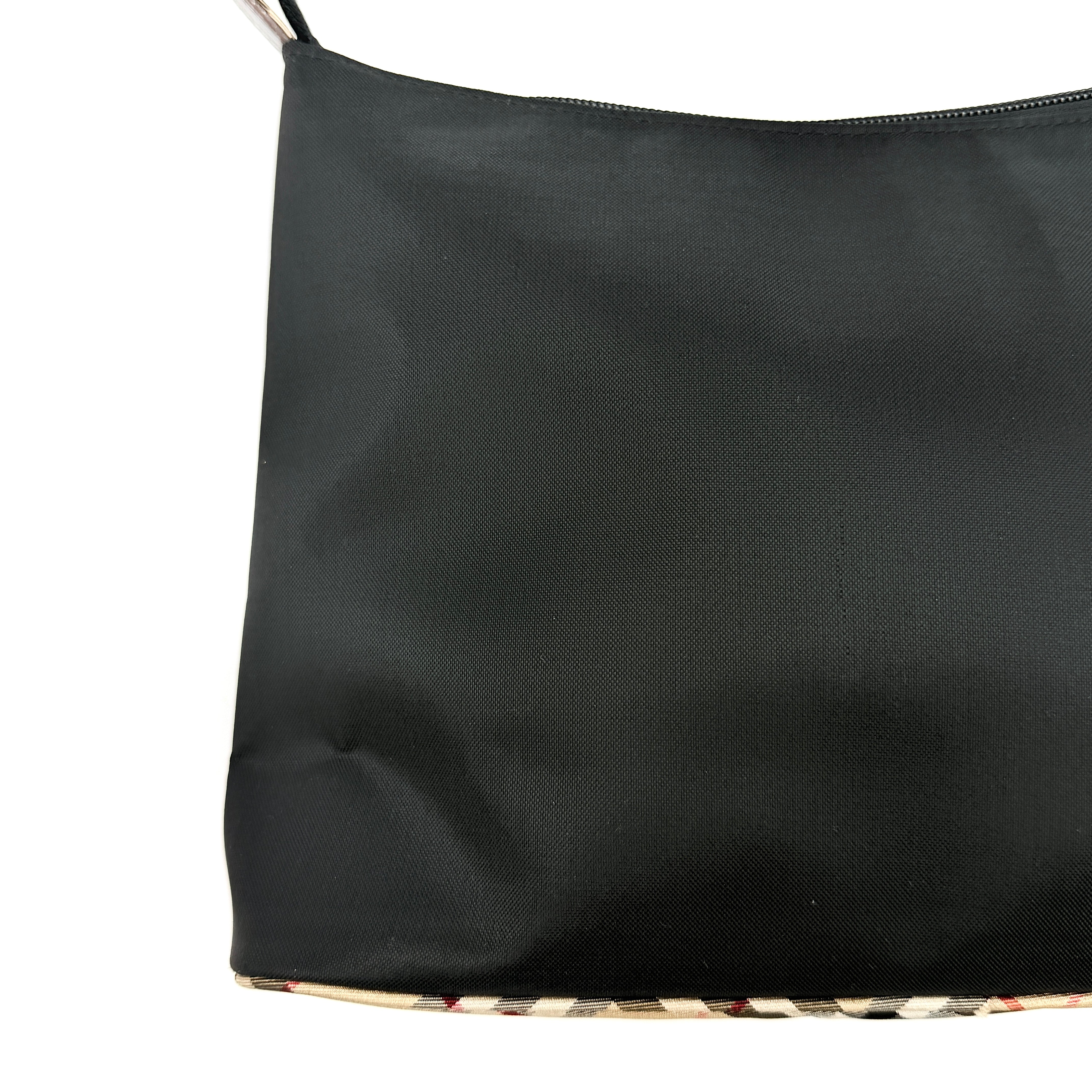 Front-facing Burberry Nova Check Nylon Shoulder Bag in black with Nova Check strap and base, shown against a clean background.