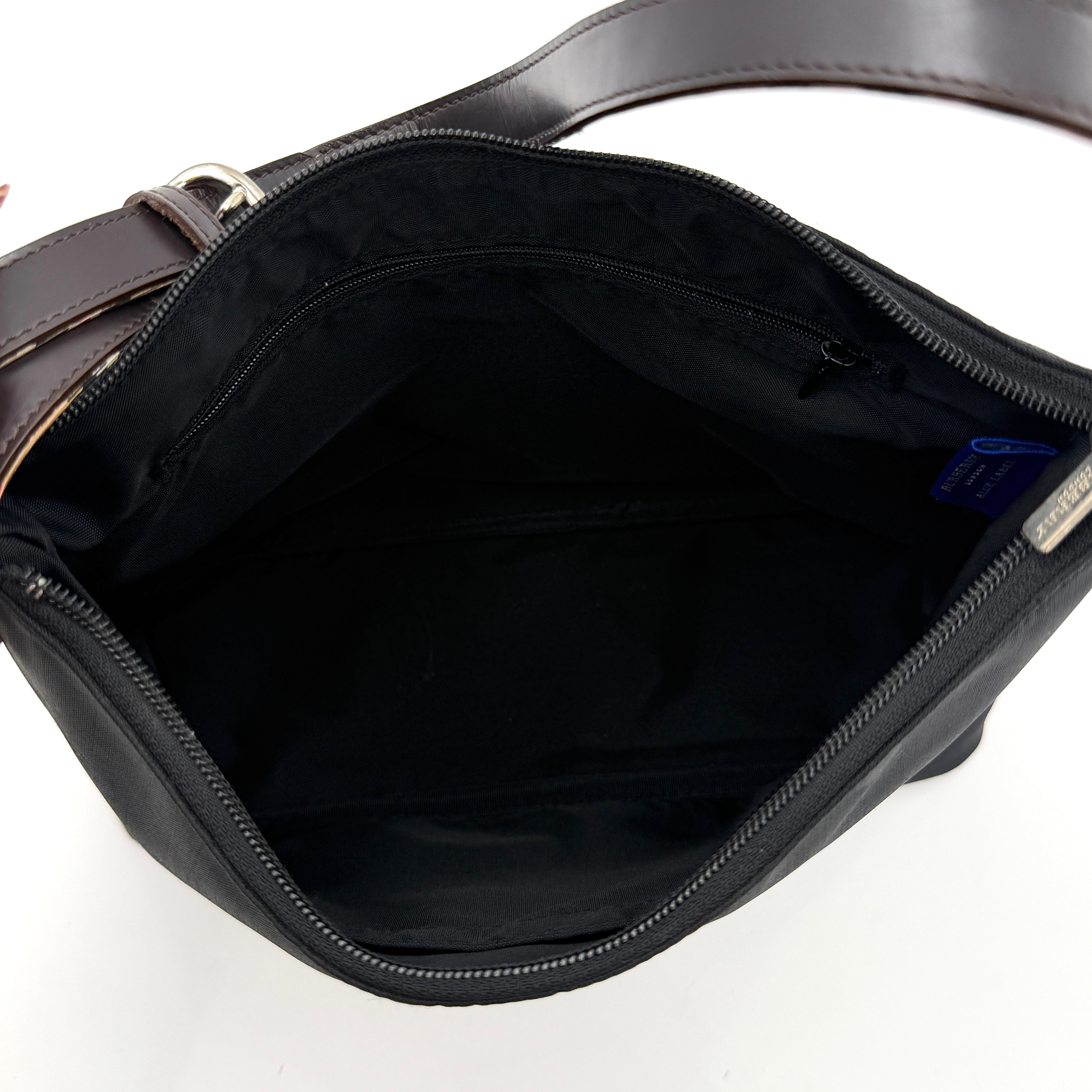 Front-facing Burberry Nova Check Nylon Shoulder Bag in black with Nova Check strap and base, shown against a clean background.