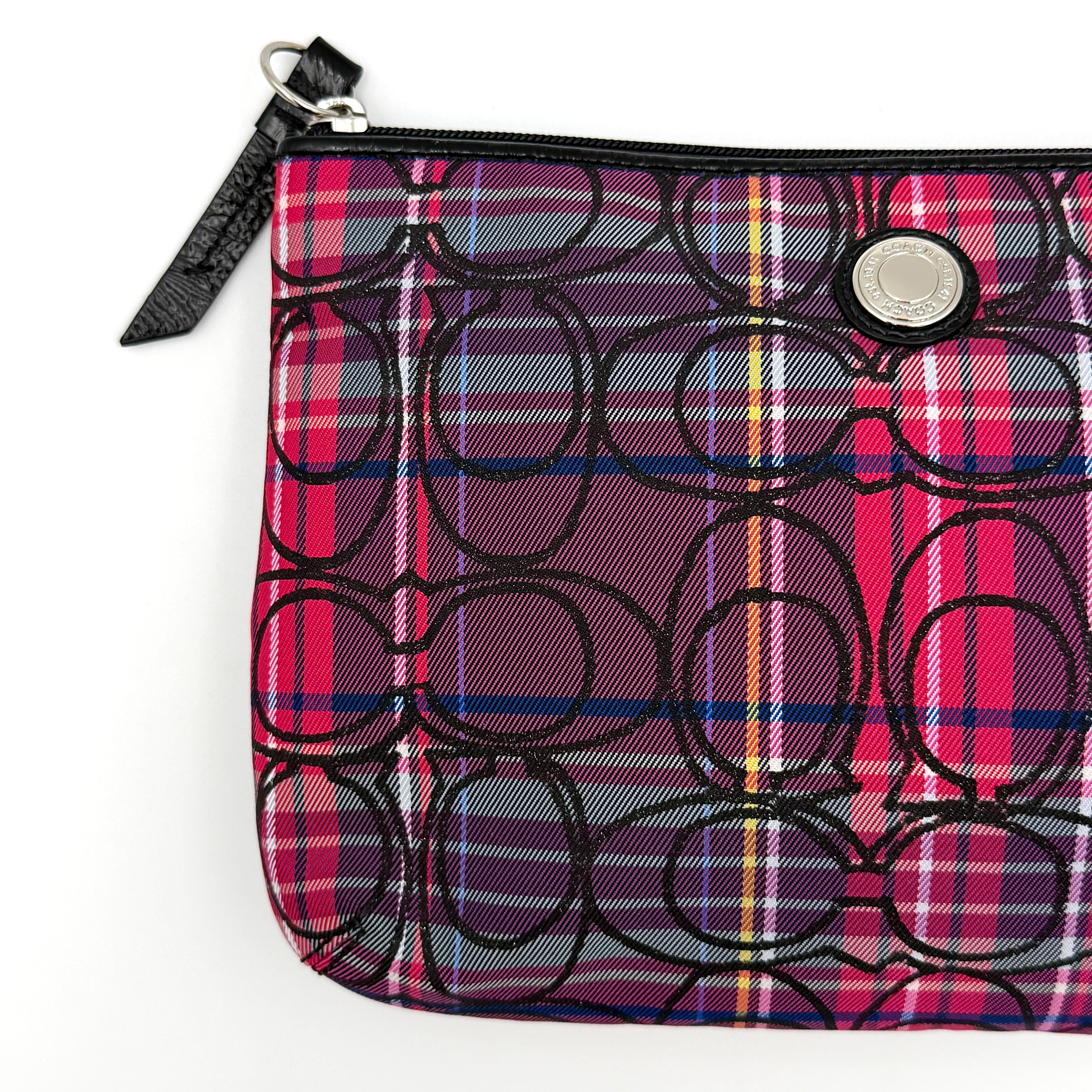Coach Signature Poppy Tartan Pouch with bold multicolour plaid and black C motif, topped by silver-tone hardware and leather zipper pull.