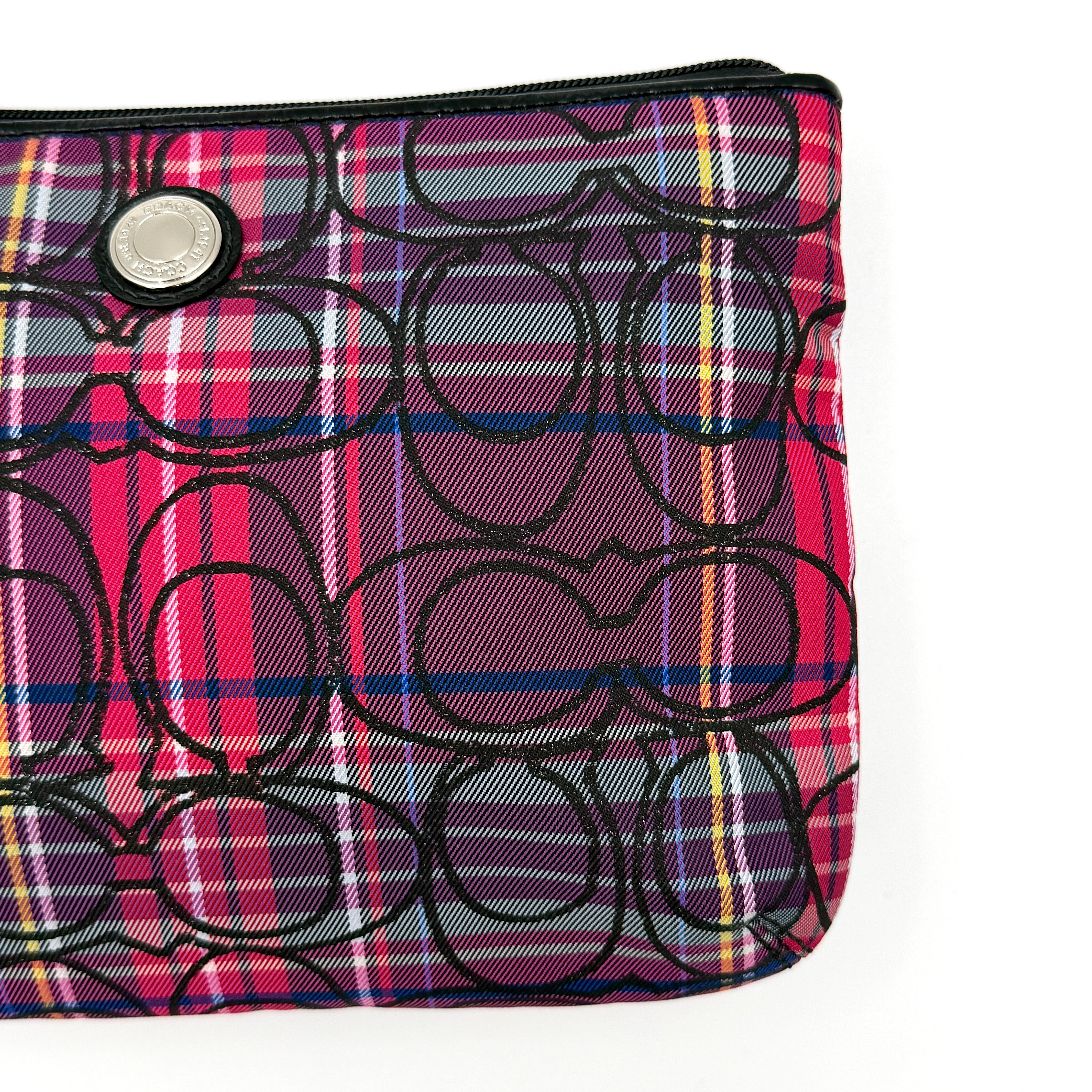 Coach Signature Poppy Tartan Pouch with bold multicolour plaid and black C motif, topped by silver-tone hardware and leather zipper pull.