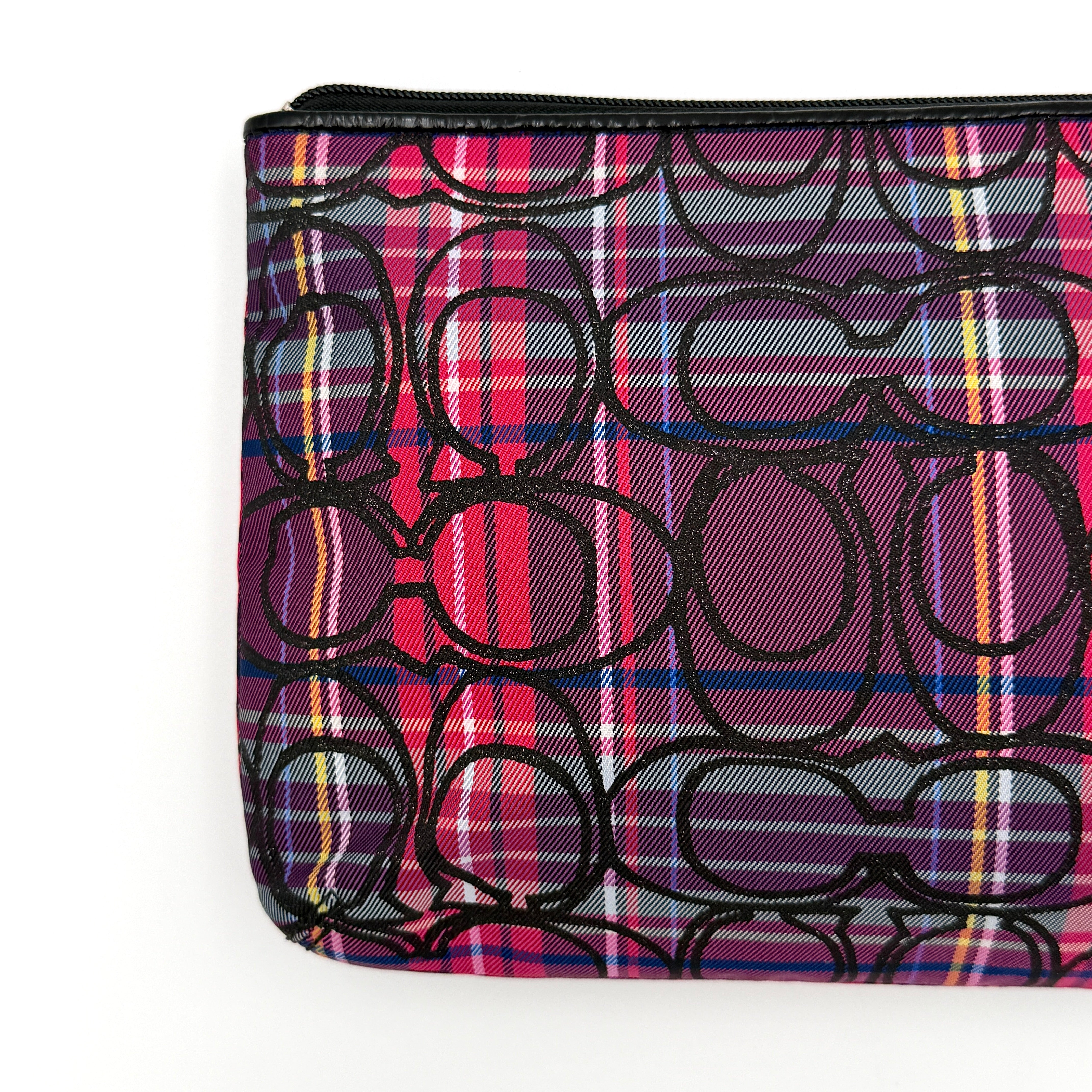 Coach Signature Poppy Tartan Pouch with bold multicolour plaid and black C motif, topped by silver-tone hardware and leather zipper pull.