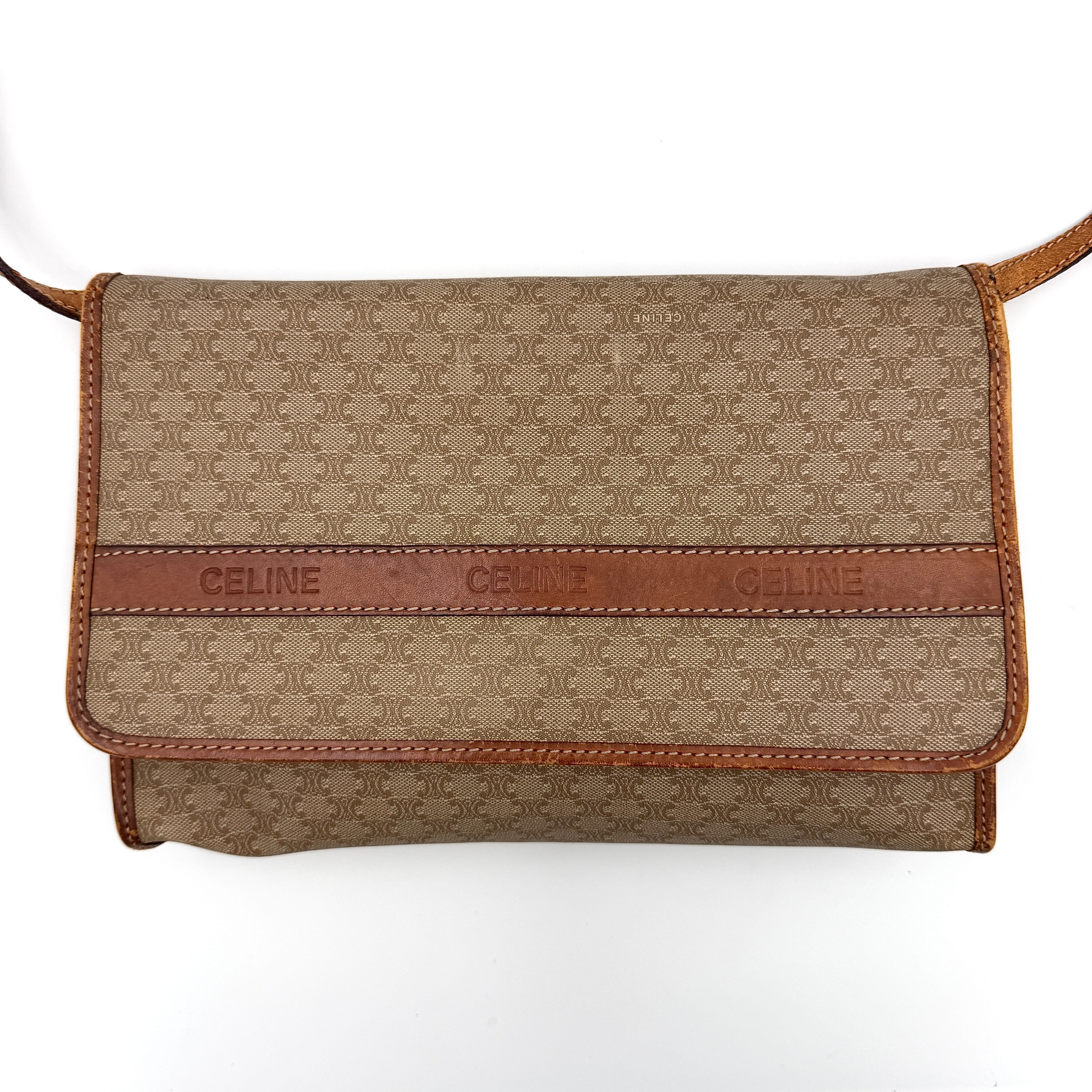 Celine Macadam PVC Crossbody Bag in brown and beige with a monogram pattern, tan leather trim, and long crossbody strap displayed against a white background.
