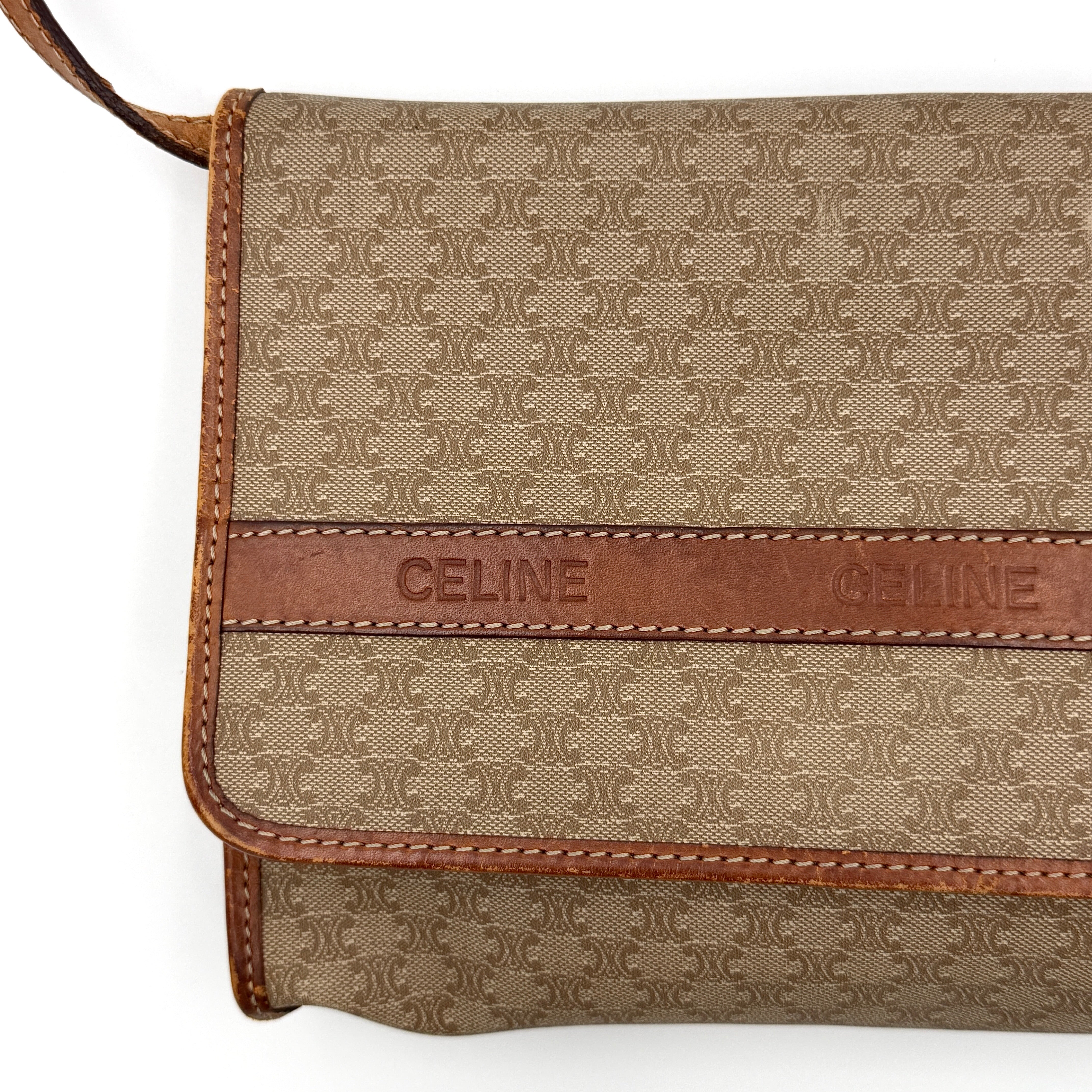 Celine Macadam PVC Crossbody Bag in brown and beige with a monogram pattern, tan leather trim, and long crossbody strap displayed against a white background.