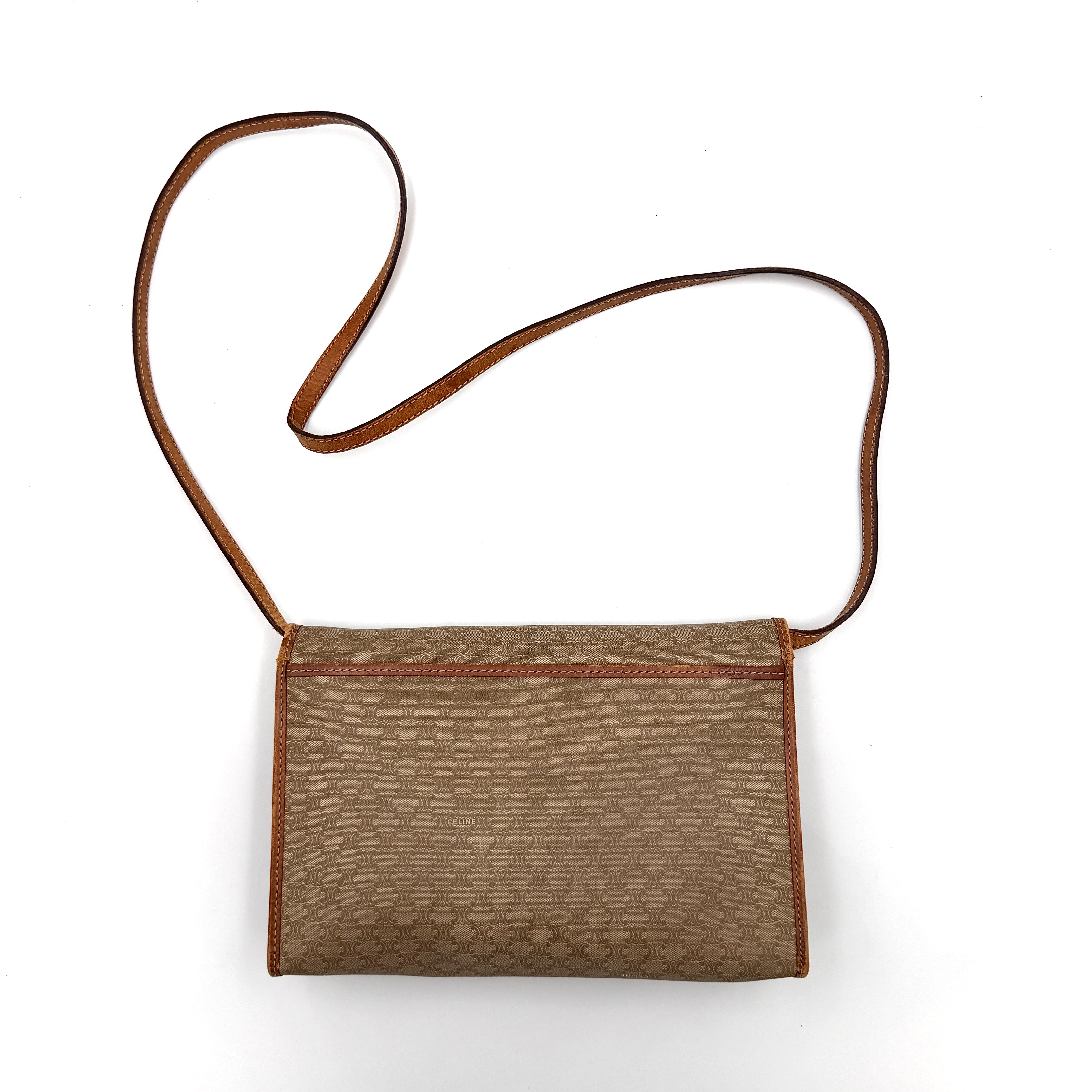 Celine Macadam PVC Crossbody Bag in brown and beige with a monogram pattern, tan leather trim, and long crossbody strap displayed against a white background.
