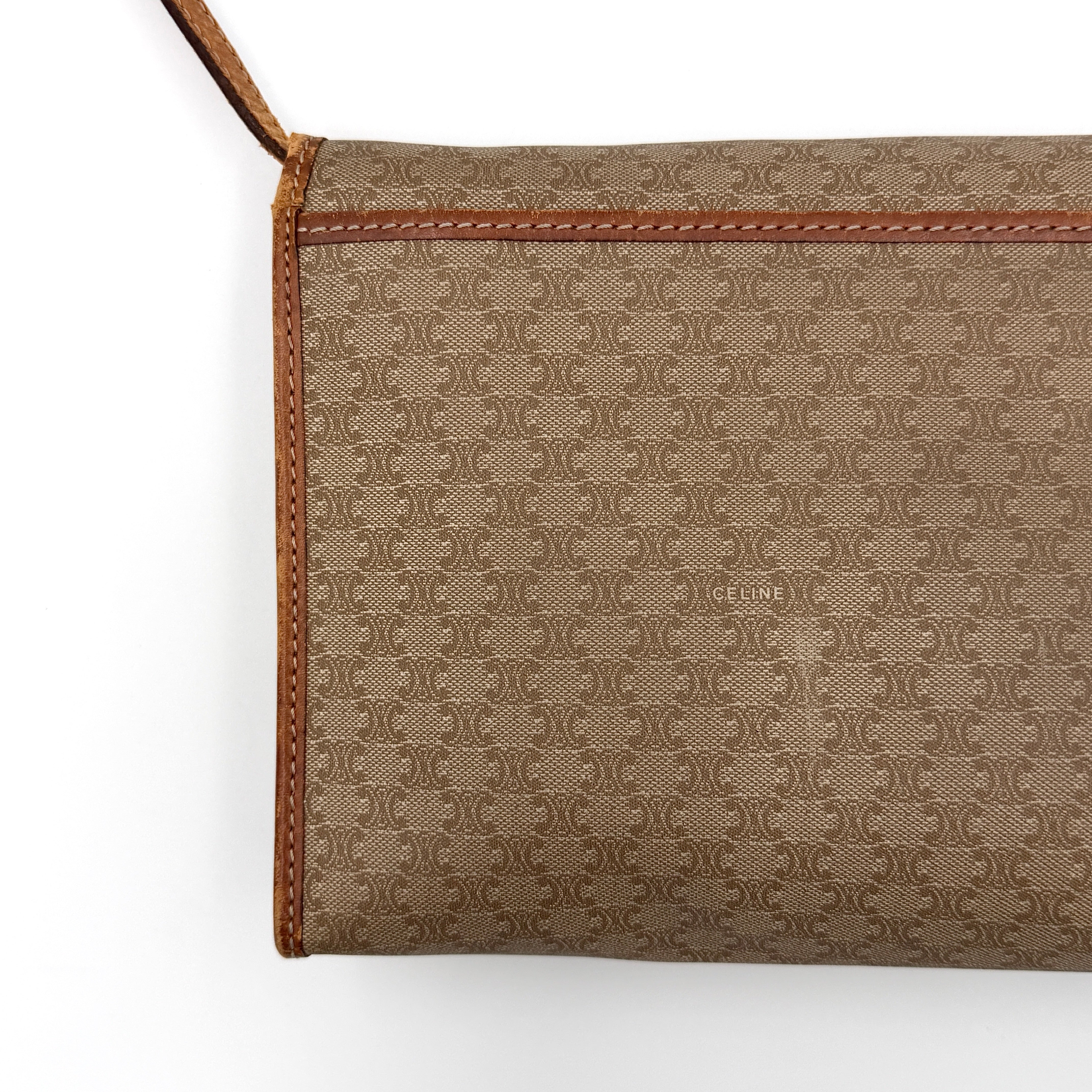 Celine Macadam PVC Crossbody Bag in brown and beige with a monogram pattern, tan leather trim, and long crossbody strap displayed against a white background.