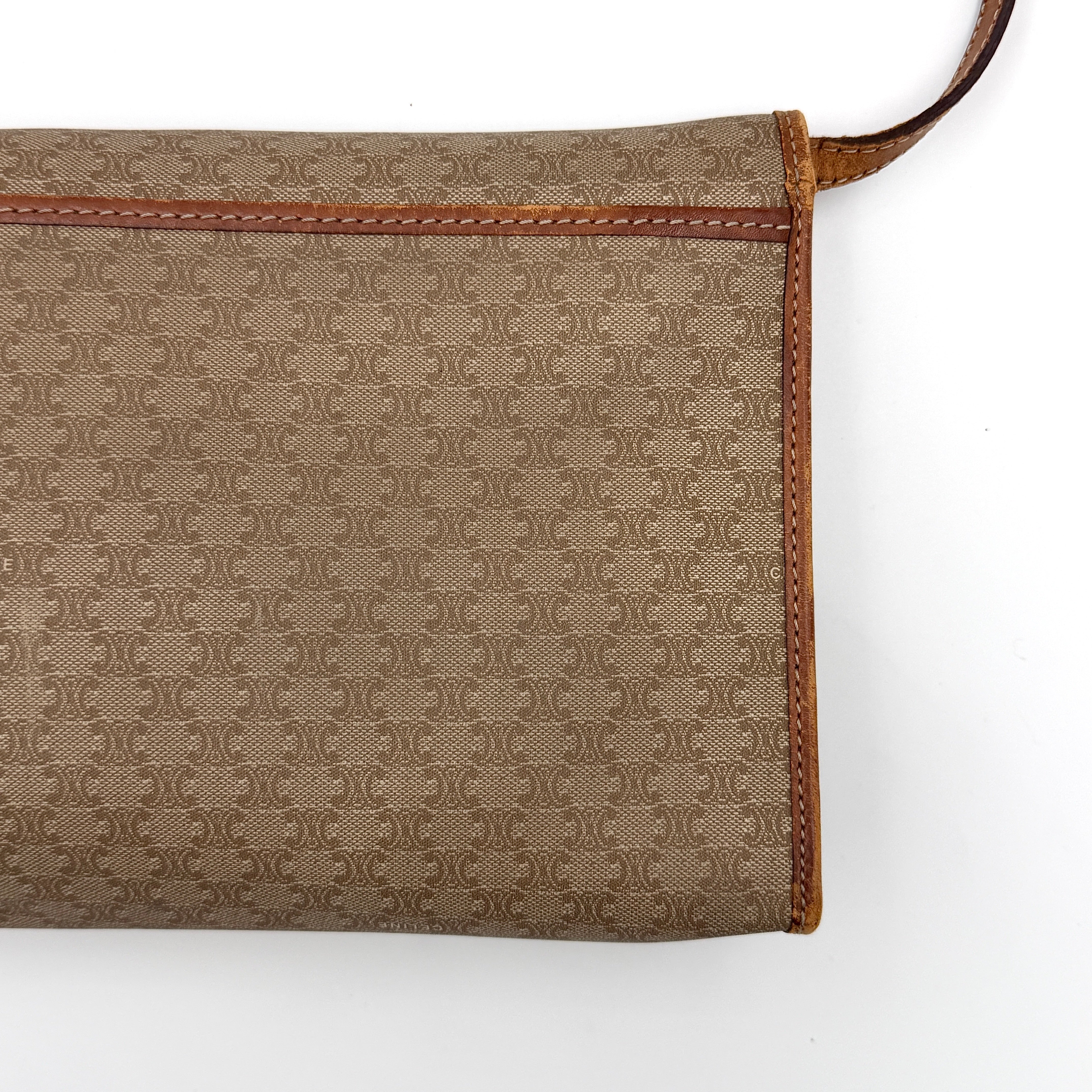 Celine Macadam PVC Crossbody Bag in brown and beige with a monogram pattern, tan leather trim, and long crossbody strap displayed against a white background.
