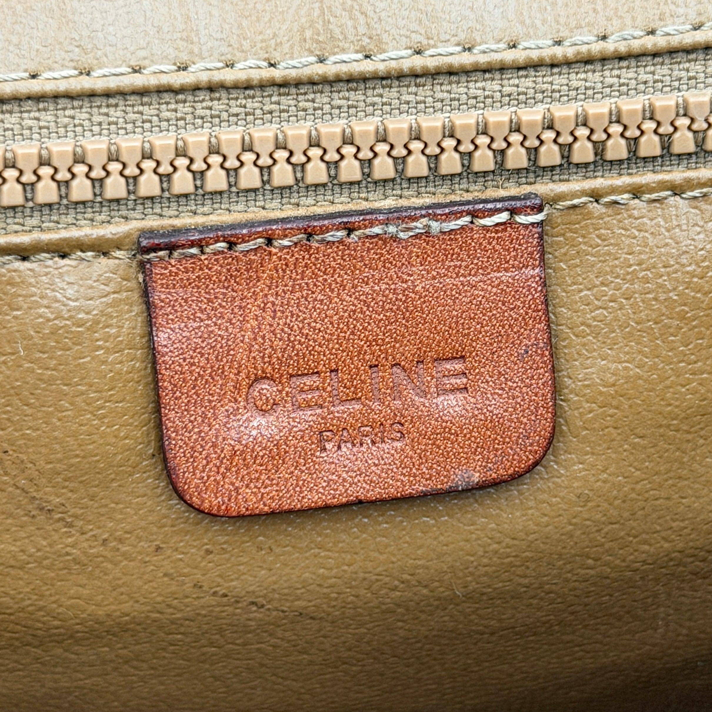 Celine Macadam PVC Crossbody Bag in brown and beige with a monogram pattern, tan leather trim, and long crossbody strap displayed against a white background.