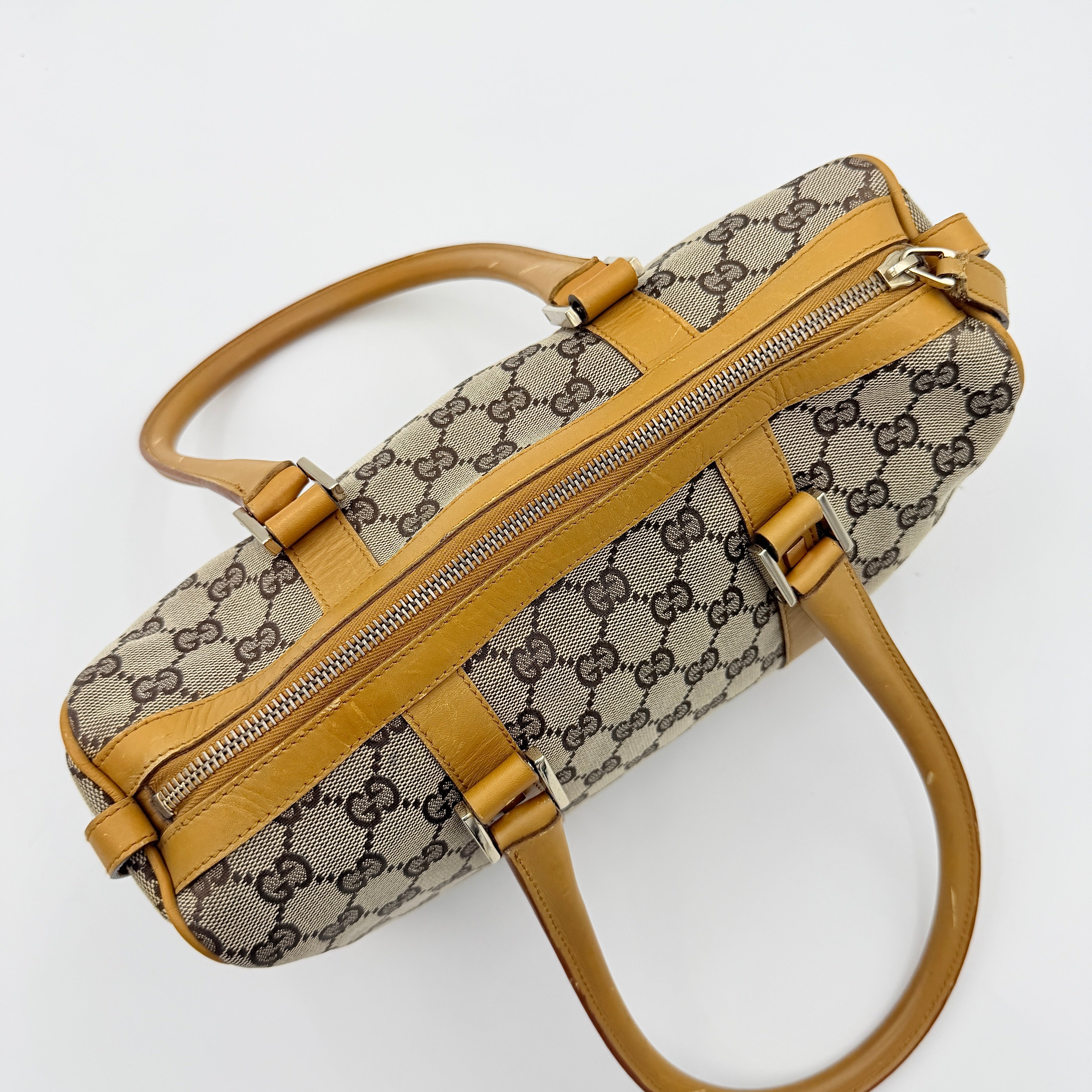 Gucci Abbey Mini Boston shoulder bag in beige GG monogram canvas with caramel leather trim and silver-tone hardware.