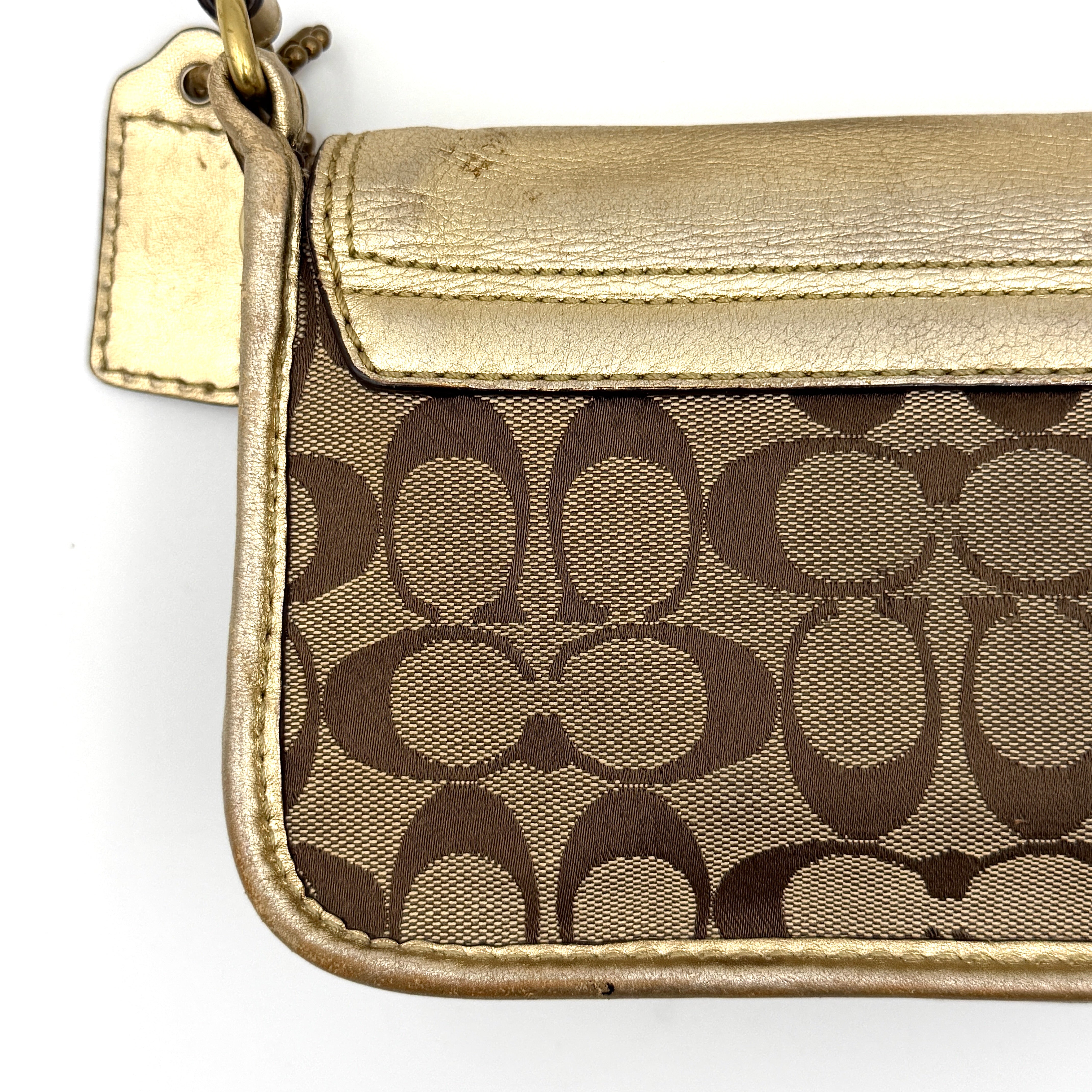 Coach Bleecker crossbody bag in gold metallic leather and beige monogram canvas with double front buckle details.