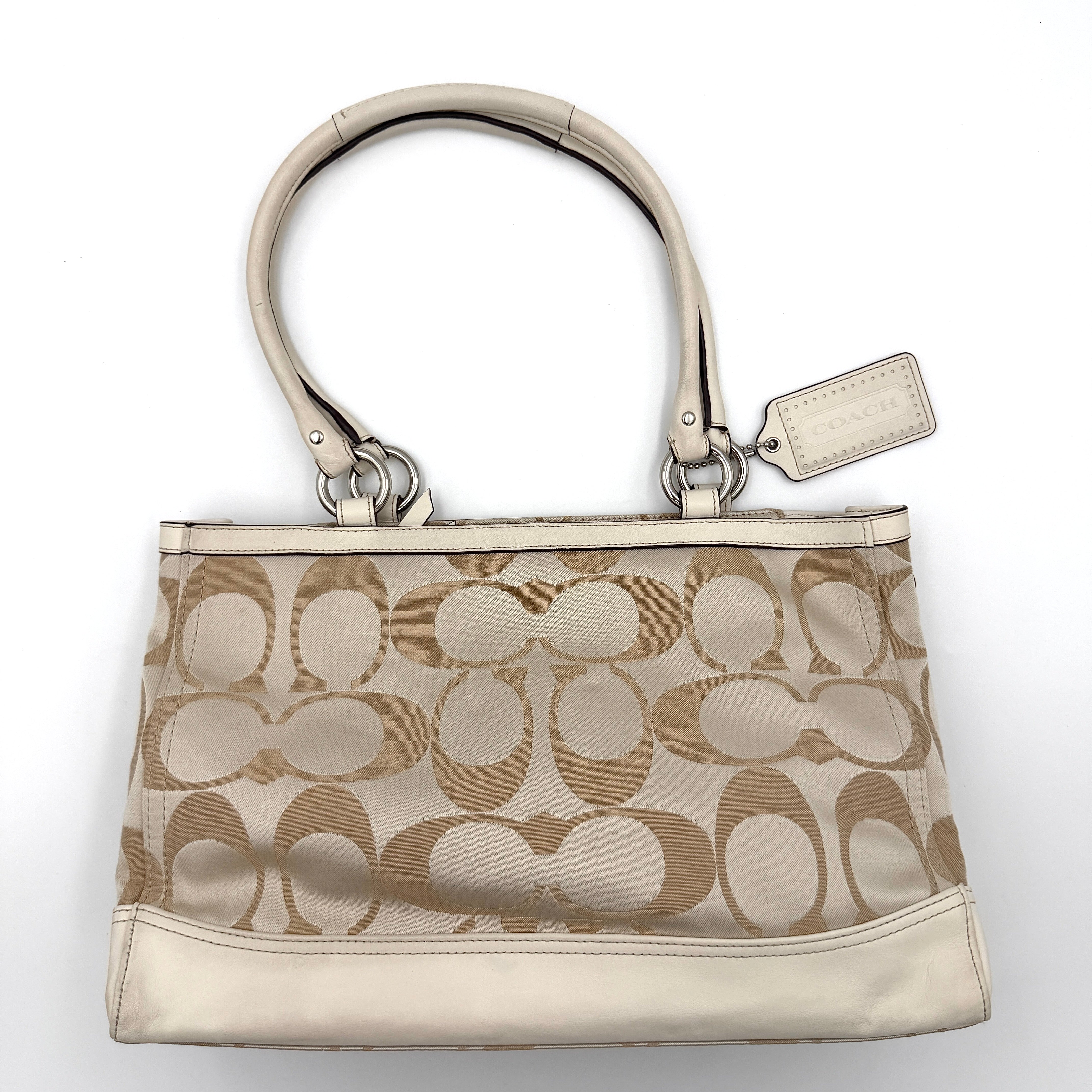 Coach Signature Carryall Shoulder Bag in beige jacquard canvas with cream leather trim and silver hardware displayed against a white background.