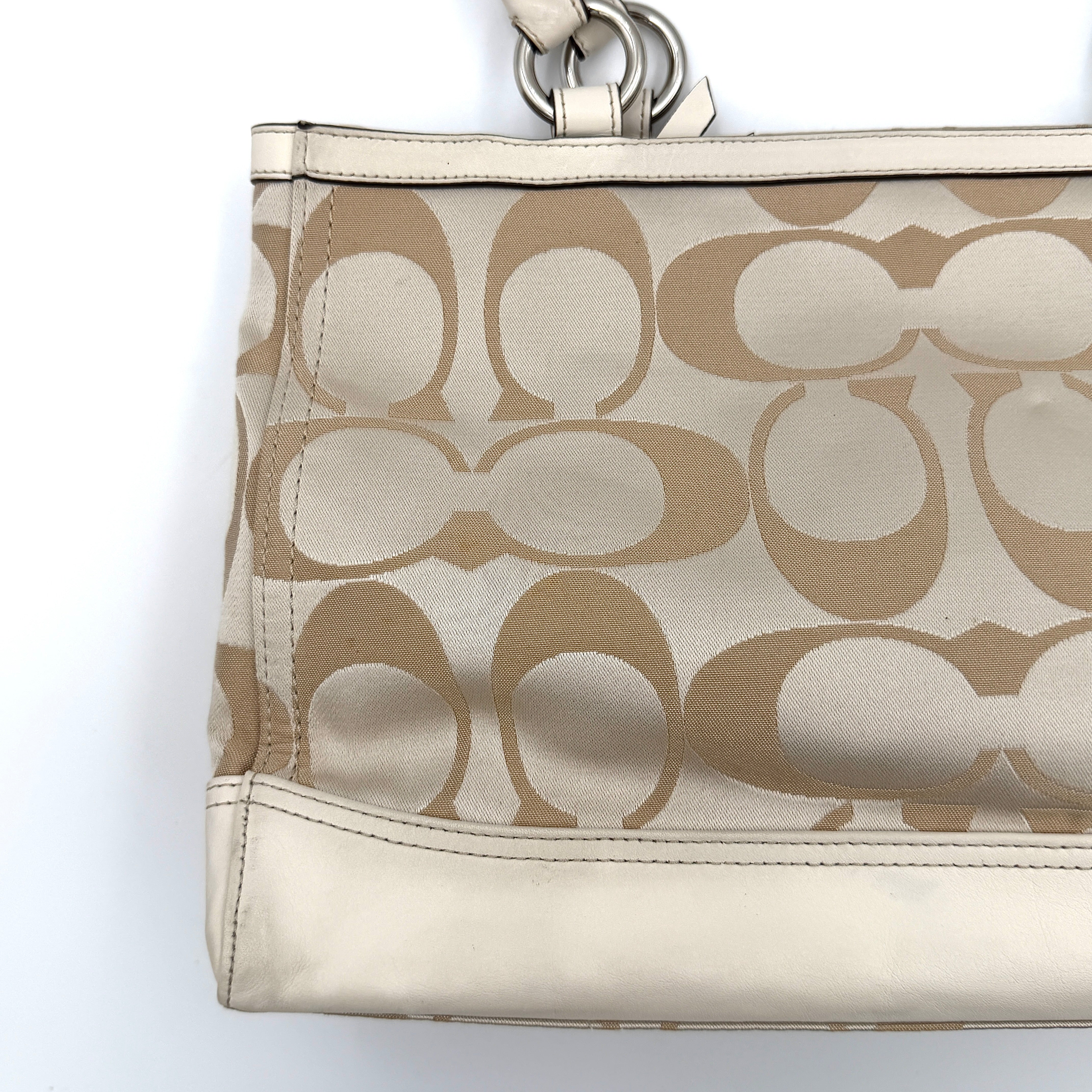 Coach Signature Carryall Shoulder Bag in beige jacquard canvas with cream leather trim and silver hardware displayed against a white background.