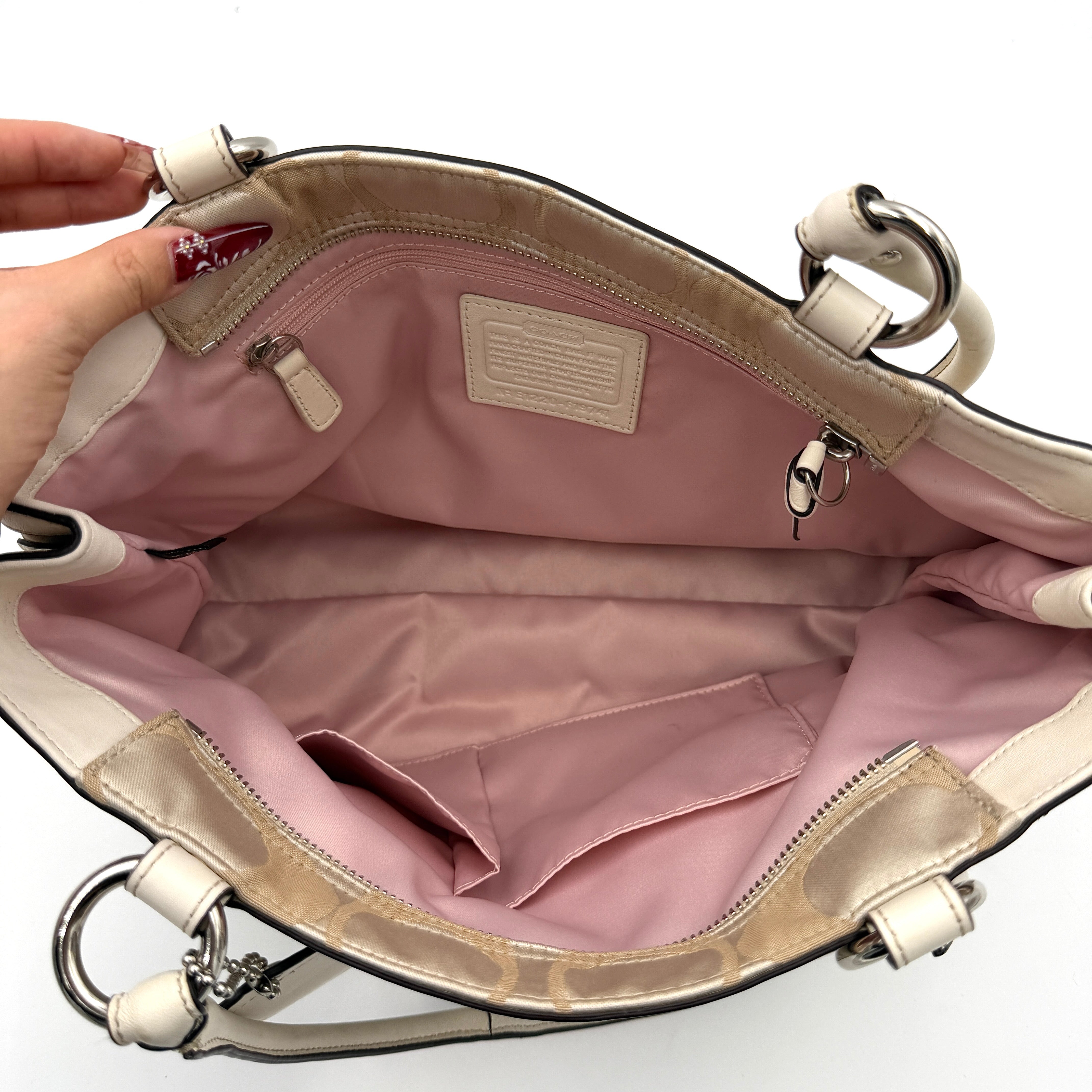 Coach Signature Carryall Shoulder Bag in beige jacquard canvas with cream leather trim and silver hardware displayed against a white background.