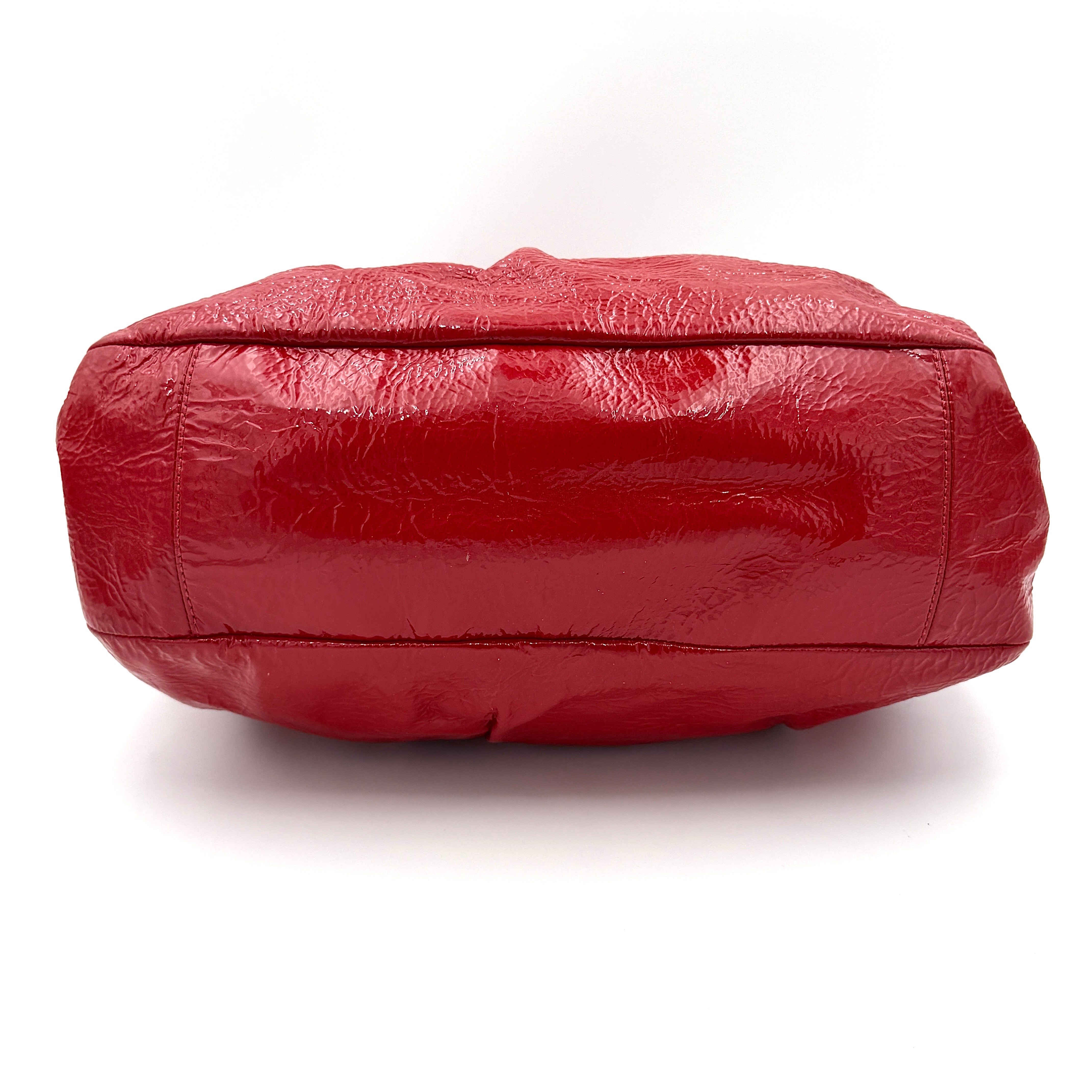 Coach Poppy 2Way shoulder bag in glossy red patent leather with floral appliqué, heart charm, double handles and detachable long strap.