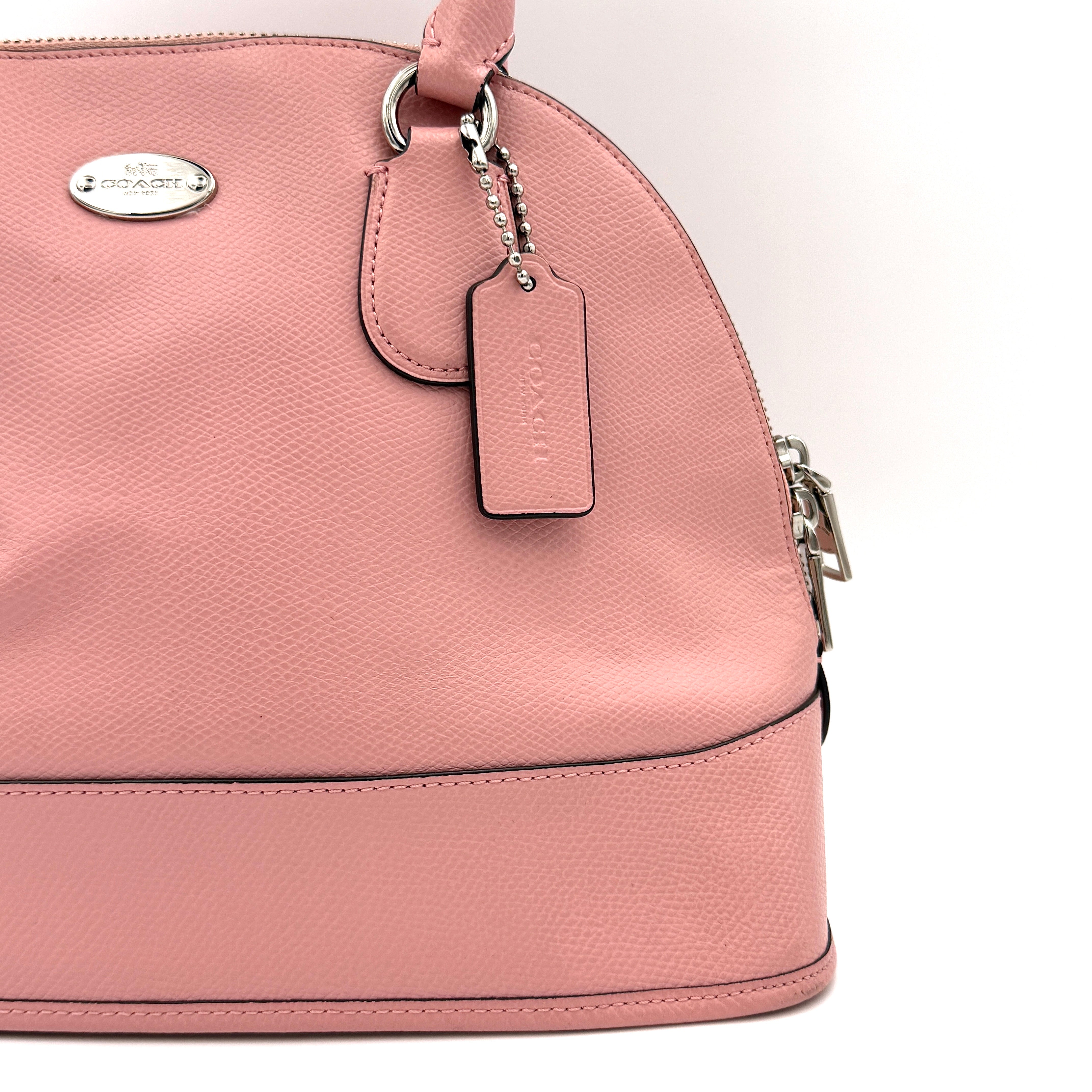 Coach Cora Domed Handbag in light pink leather with silver hardware, styled with double handles and detachable strap.