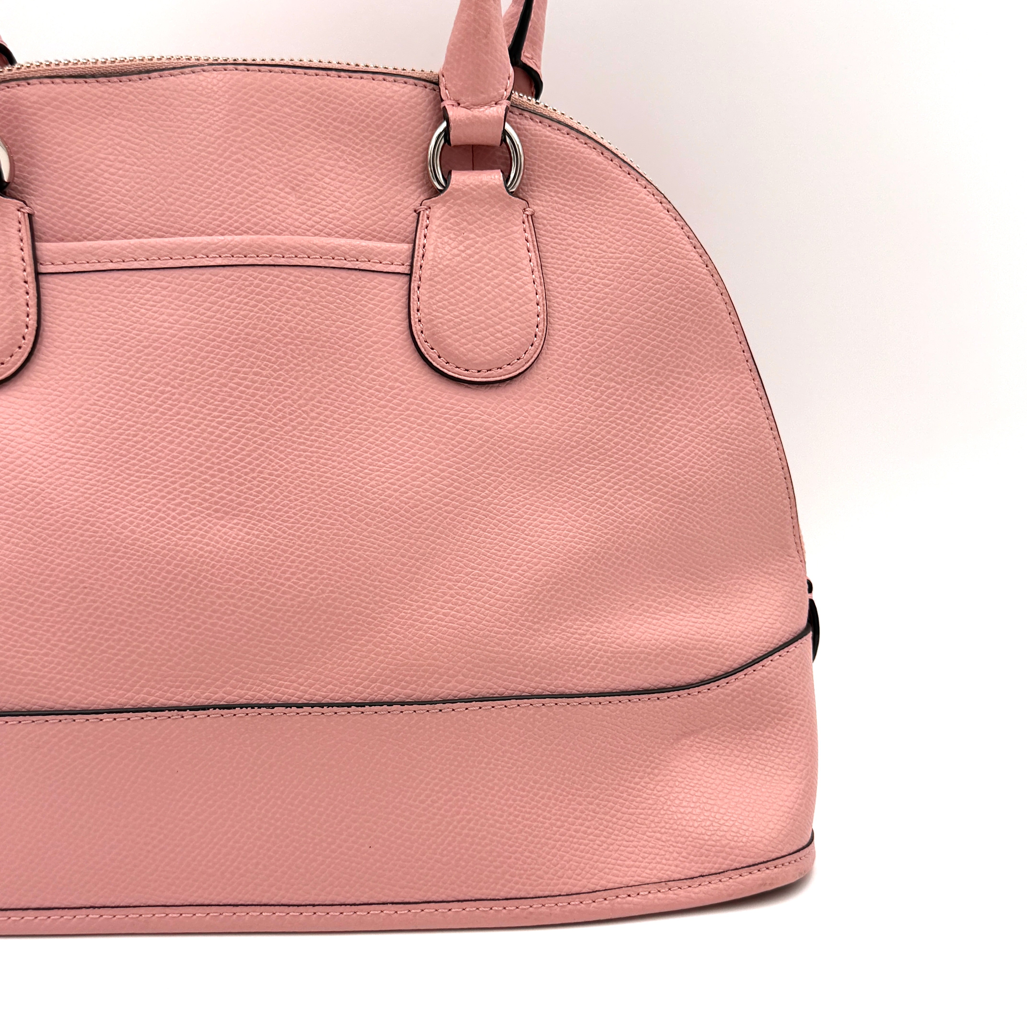 Coach Cora Domed Handbag in light pink leather with silver hardware, styled with double handles and detachable strap.