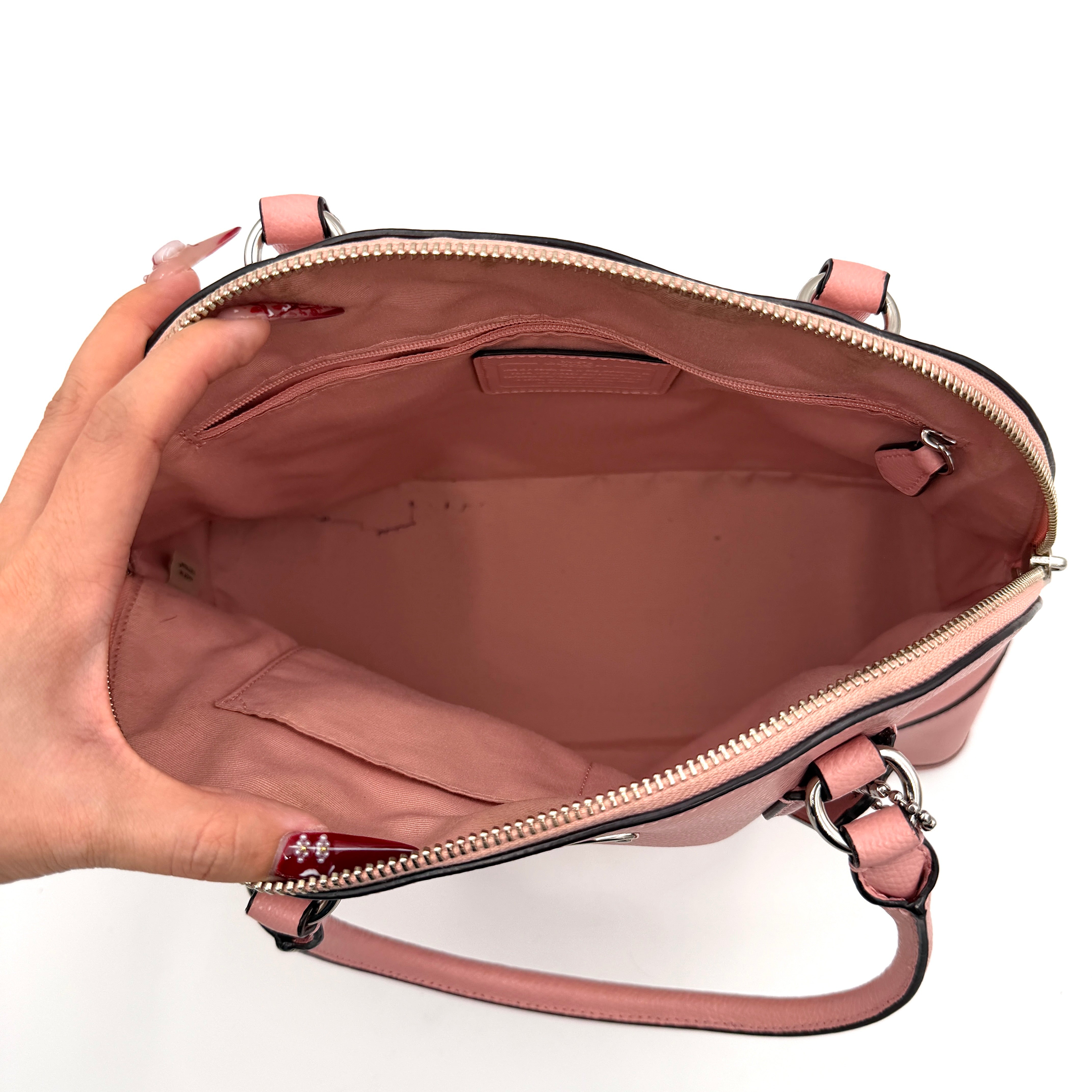 Coach Cora Domed Handbag in light pink leather with silver hardware, styled with double handles and detachable strap.