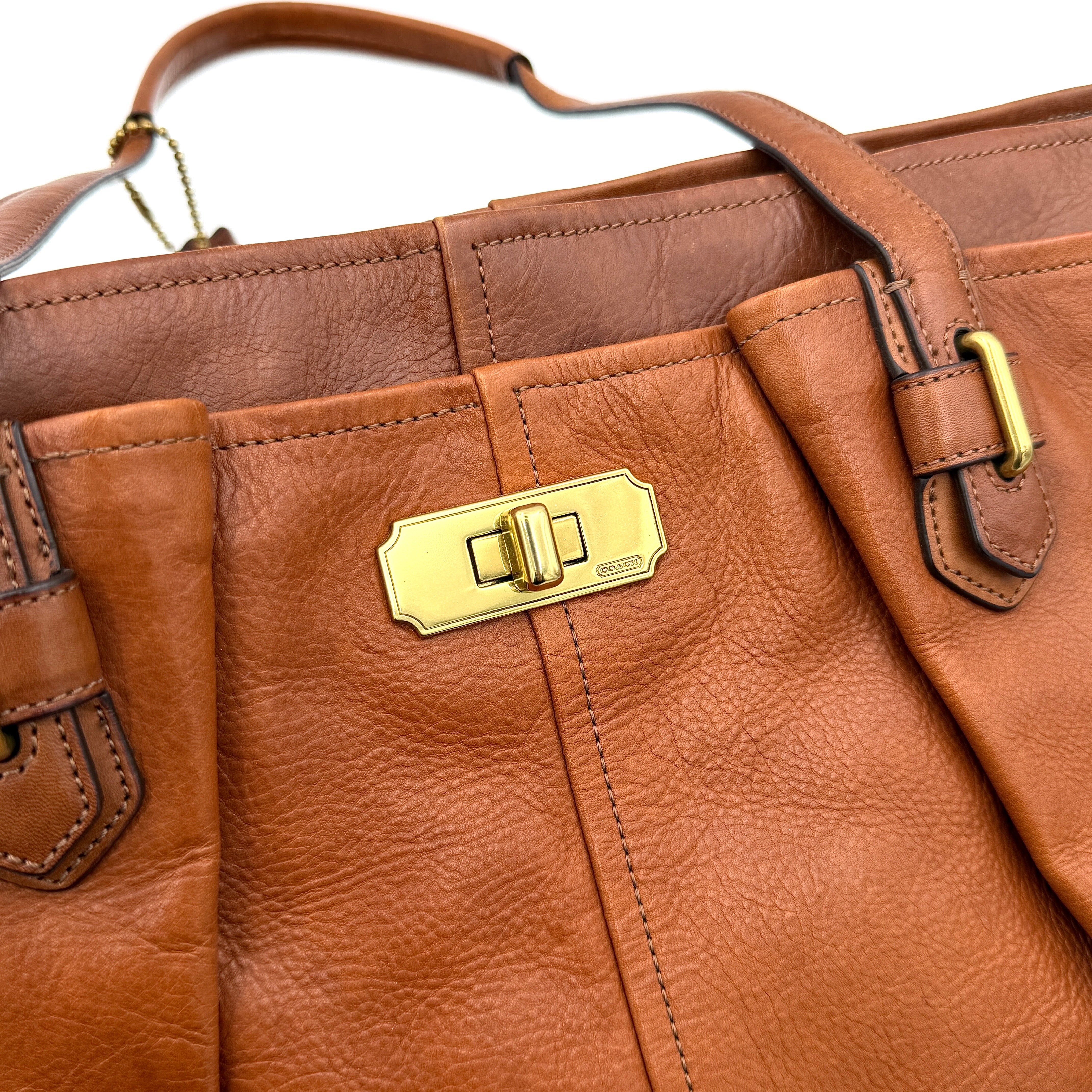 Coach Chelsea Jayden Shoulder Bag in rich brown grained leather, with gold-tone turn-lock and subtle pleated detailing.