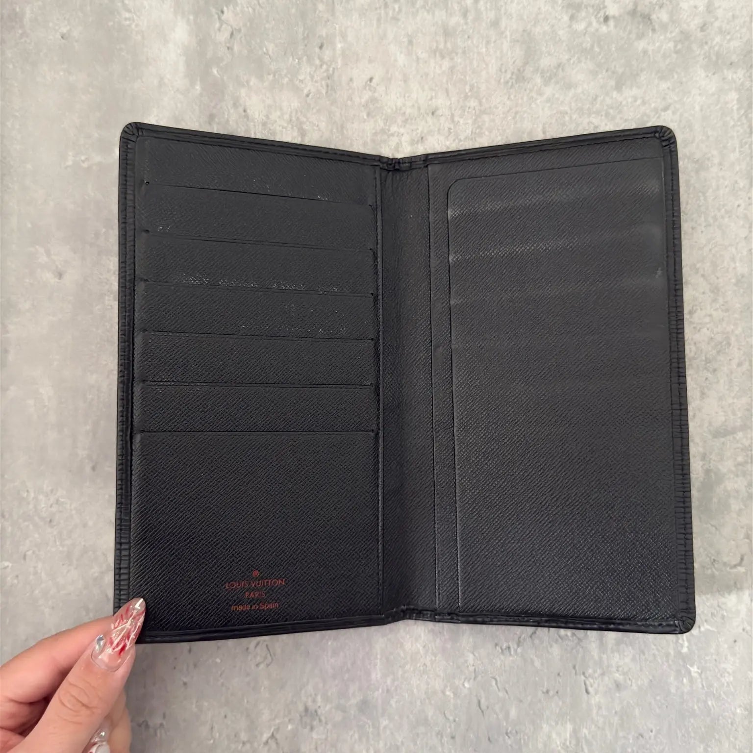 Louis Vuitton Porte Yen Cartes Credit Long Wallet in black Epi leather, featuring multiple card slots, a bill compartment, and LV embossed logo, epitomizing luxury and functionality.