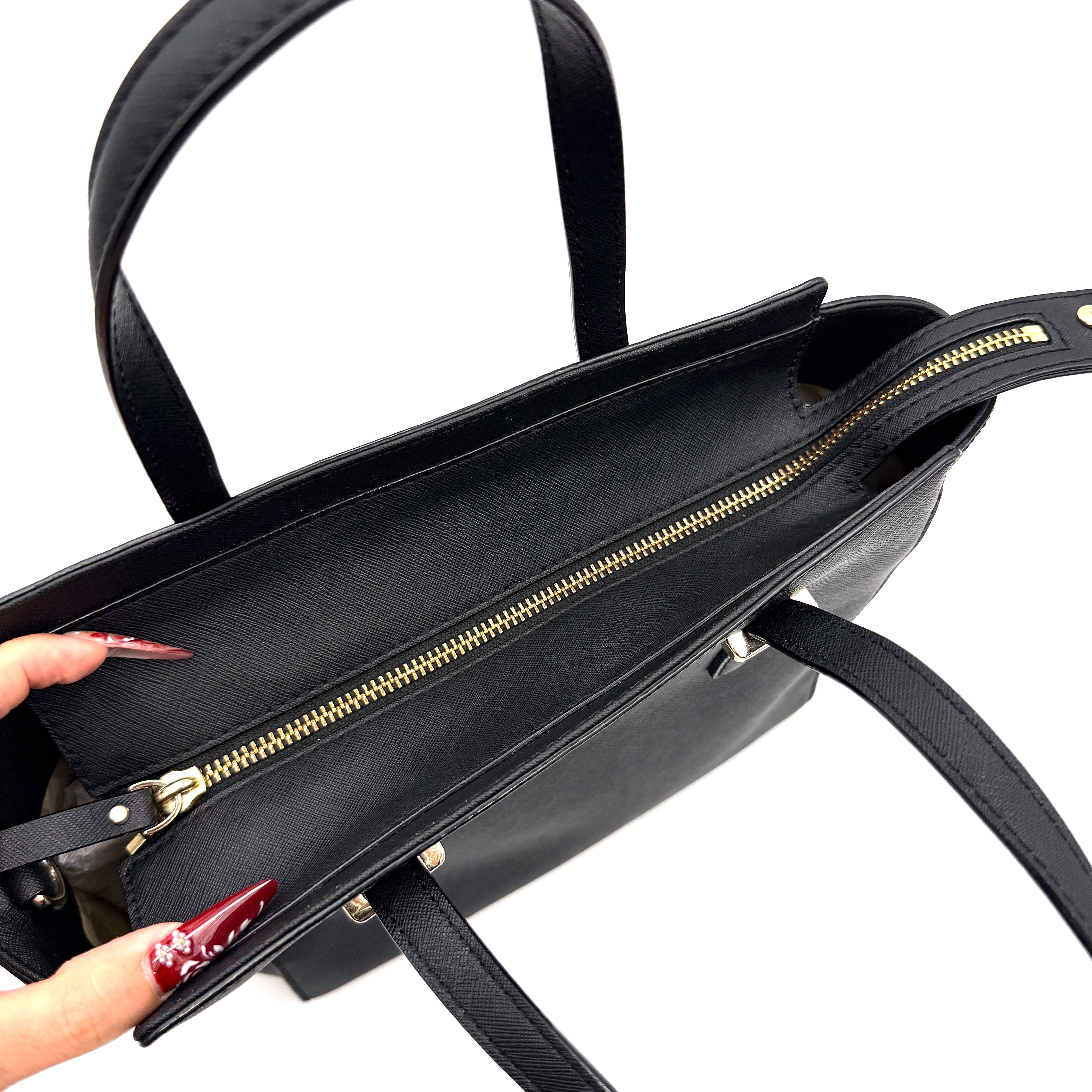 Kate Spade black Hayden handbag with structured handles and a detachable strap displayed beside it.