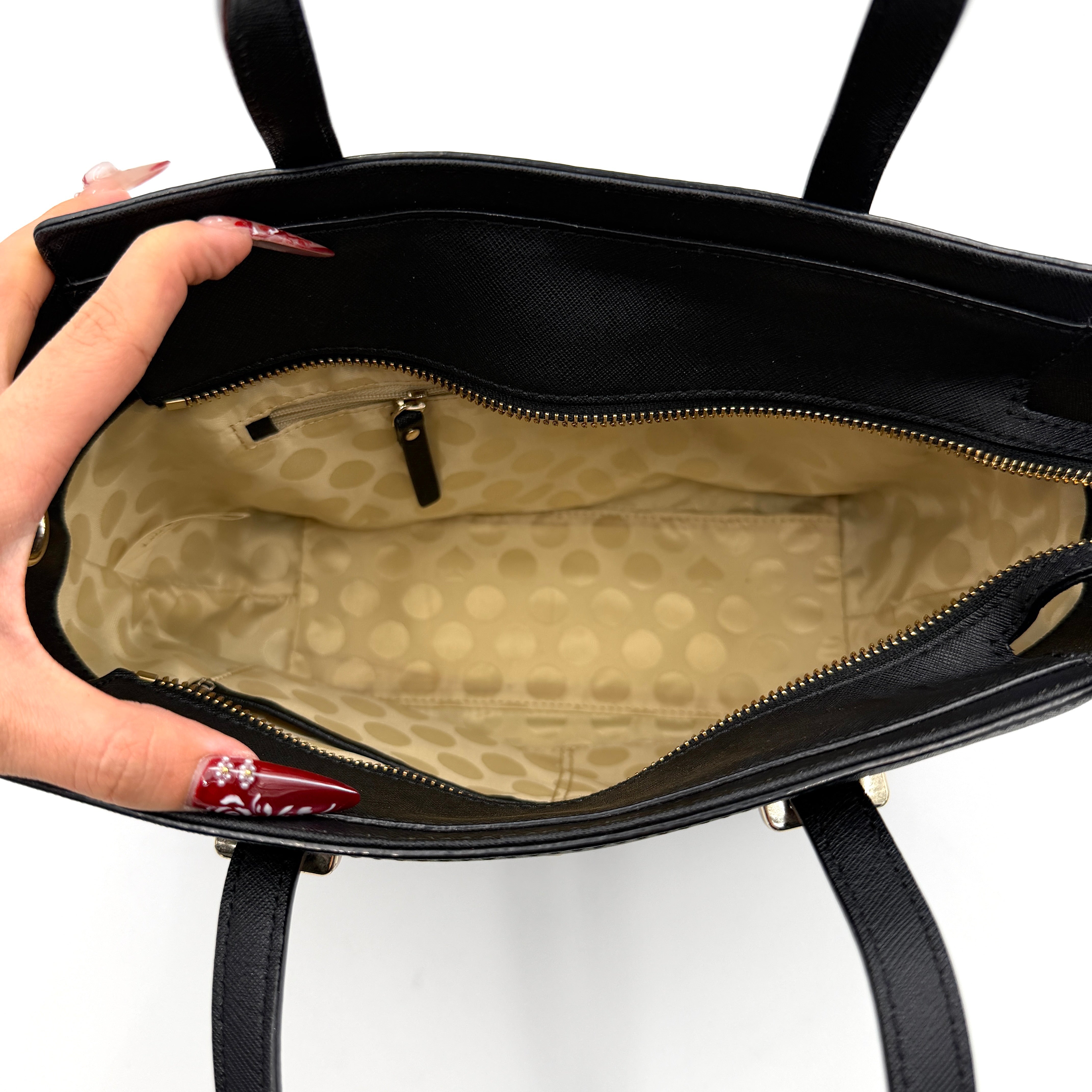 Kate Spade black Hayden handbag with structured handles and a detachable strap displayed beside it.