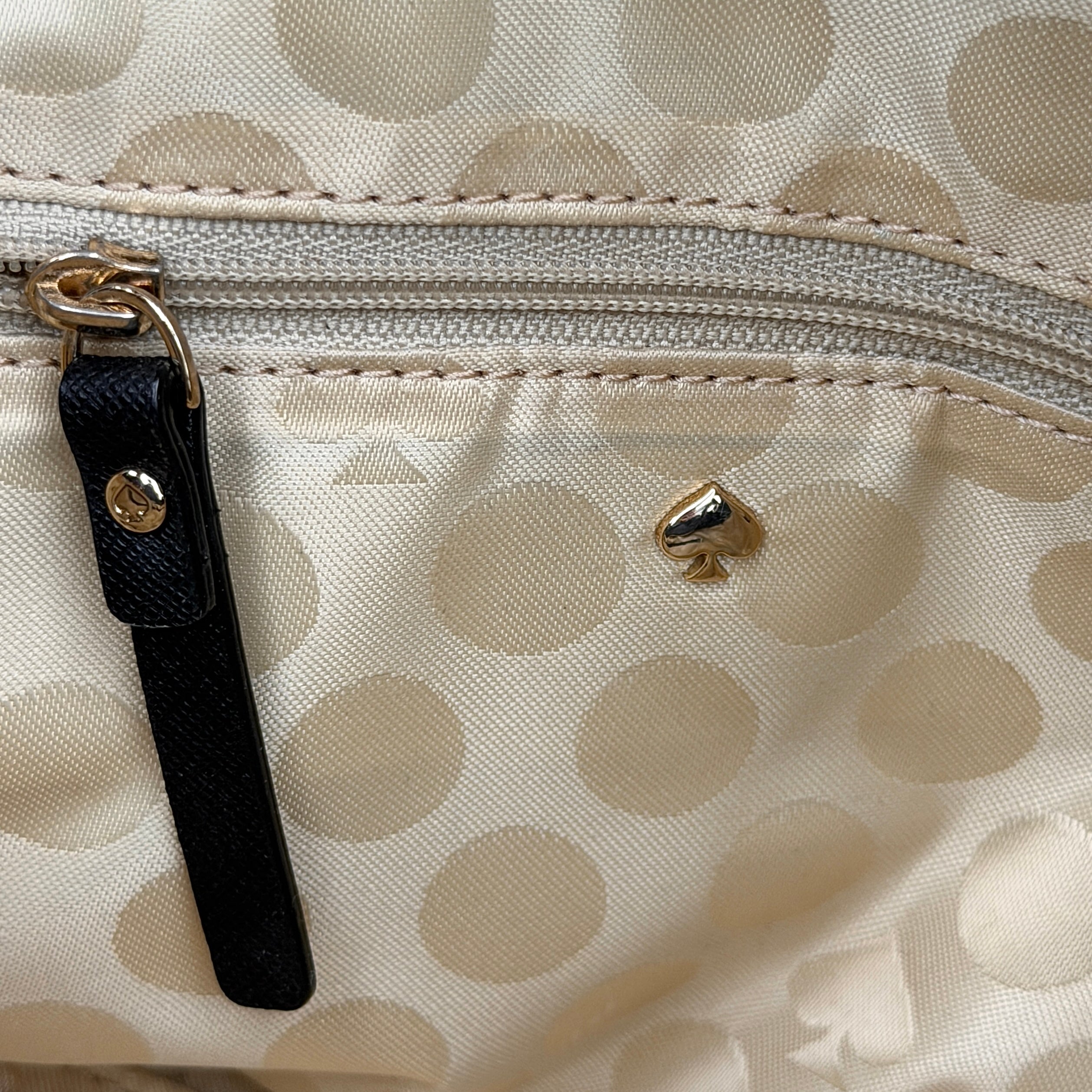 Kate Spade black Hayden handbag with structured handles and a detachable strap displayed beside it.