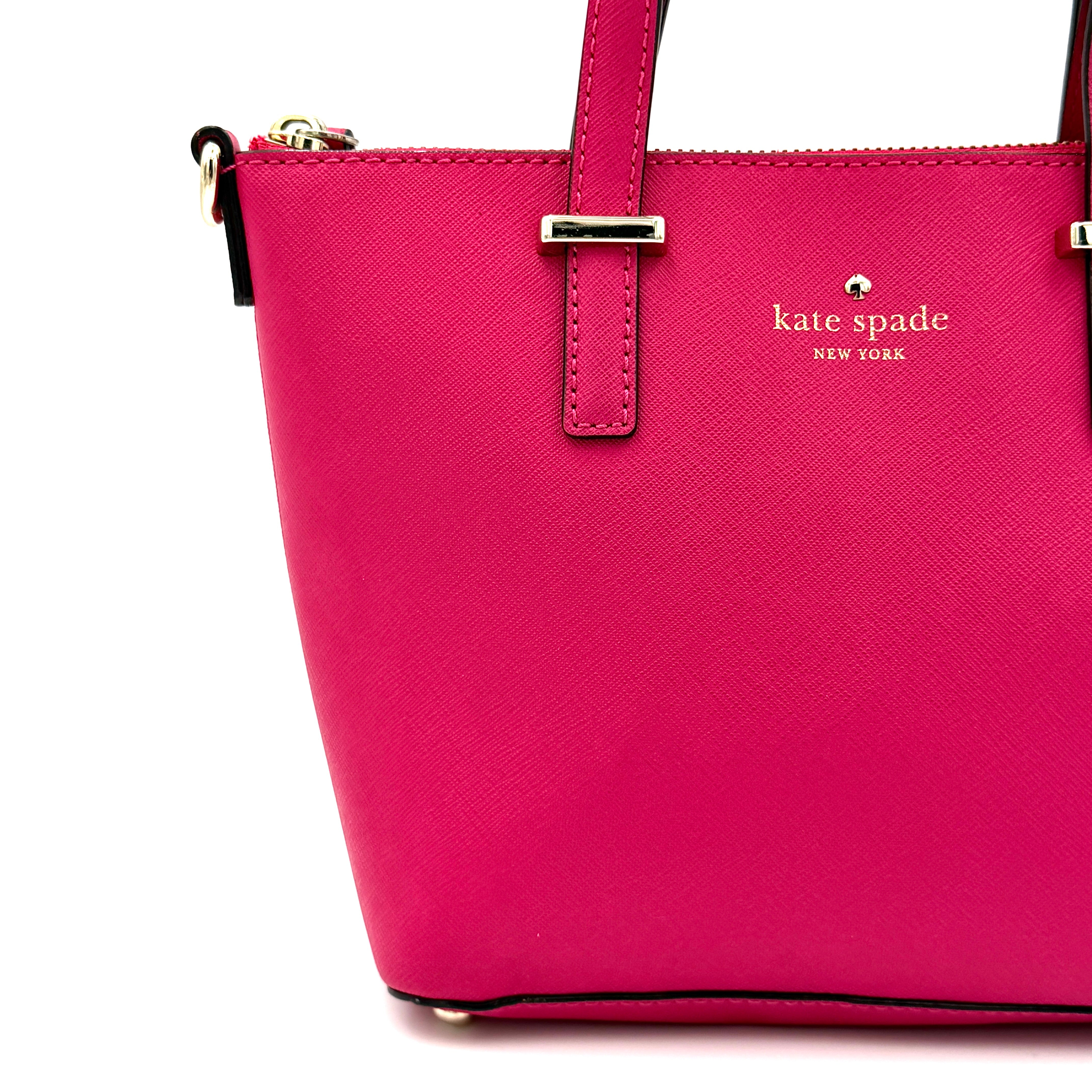 Kate Spade Cedar Street handbag in bold fuchsia pink Saffiano leather, shown with top handles and detachable strap alongside.