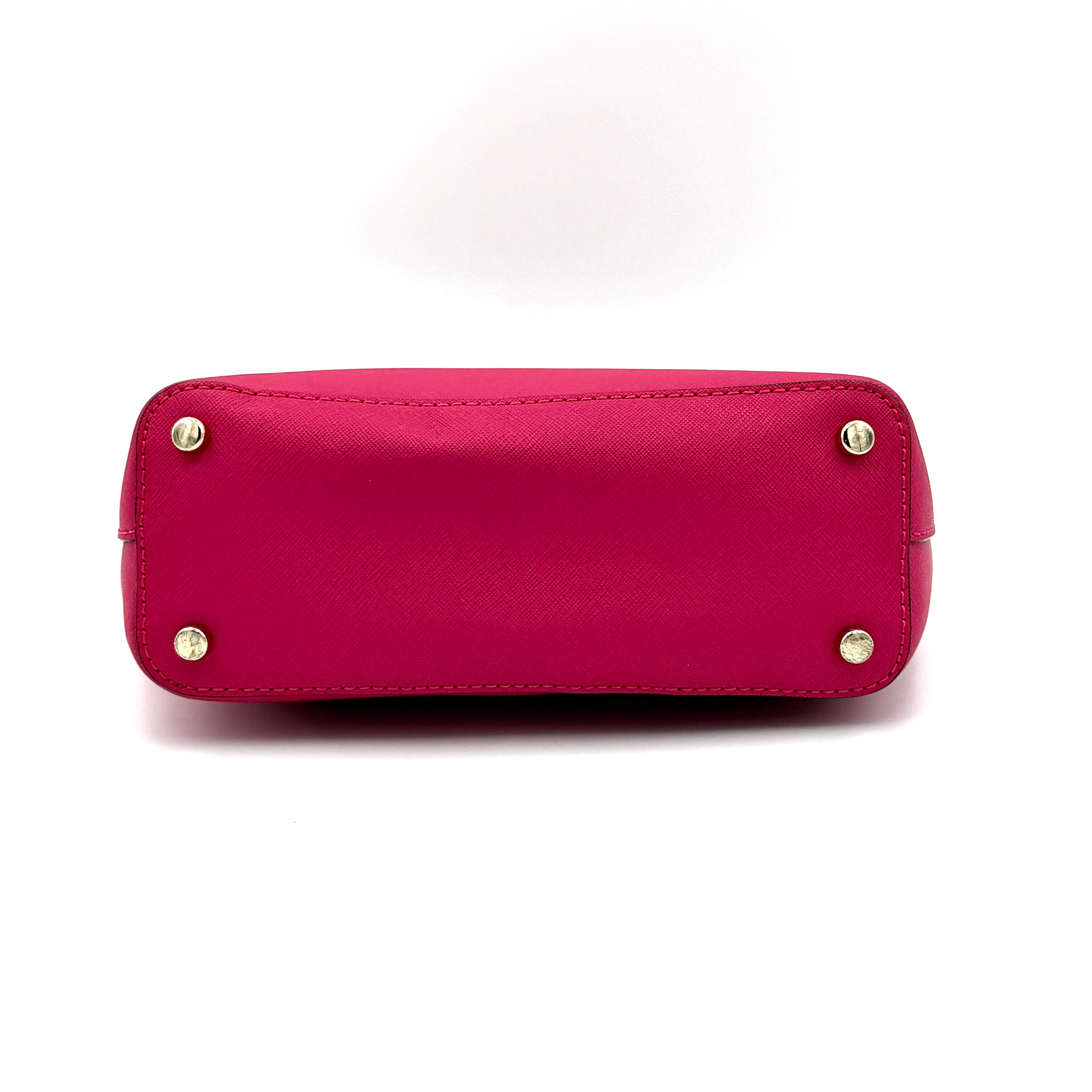 Kate Spade Cedar Street handbag in bold fuchsia pink Saffiano leather, shown with top handles and detachable strap alongside.