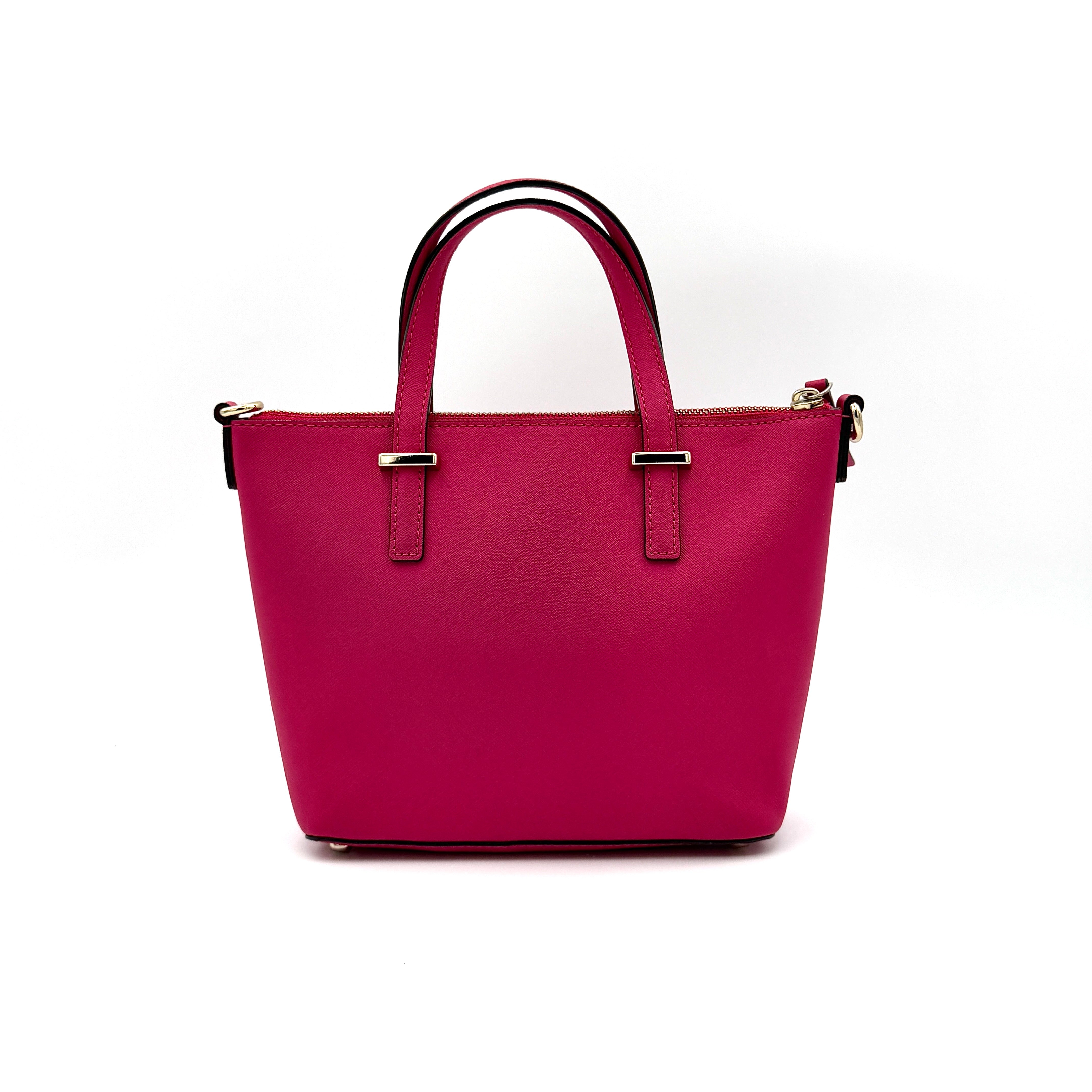Kate Spade Cedar Street handbag in bold fuchsia pink Saffiano leather, shown with top handles and detachable strap alongside.